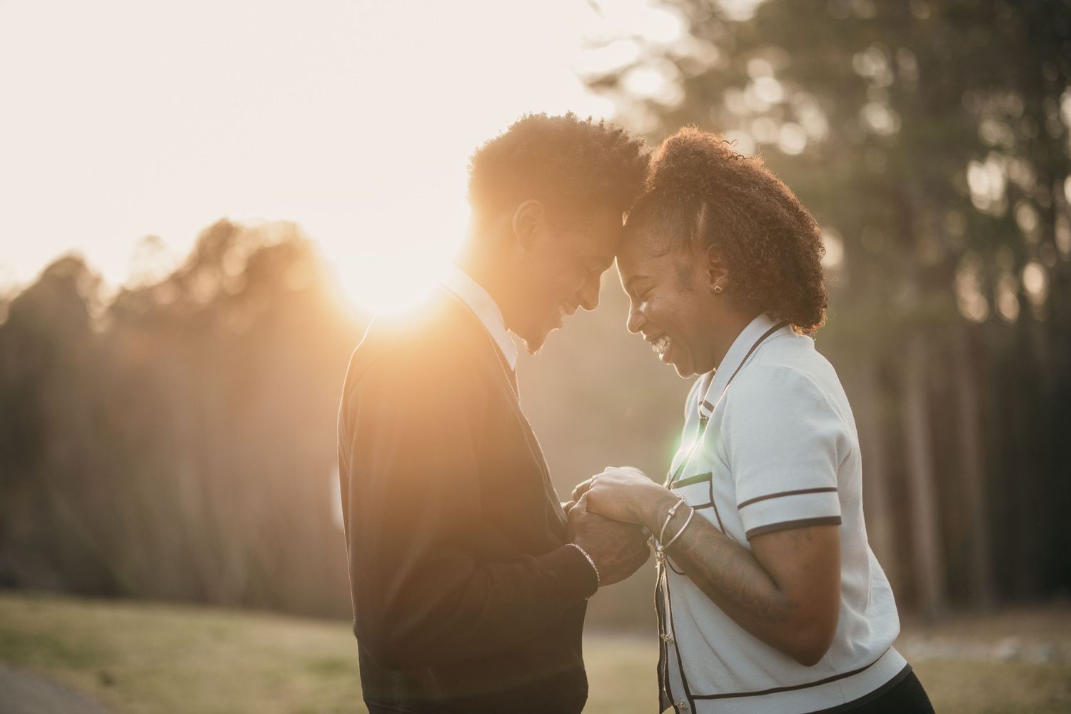 young black couple sharing intimate moment during golden hour couples session in Suwanee, GA.