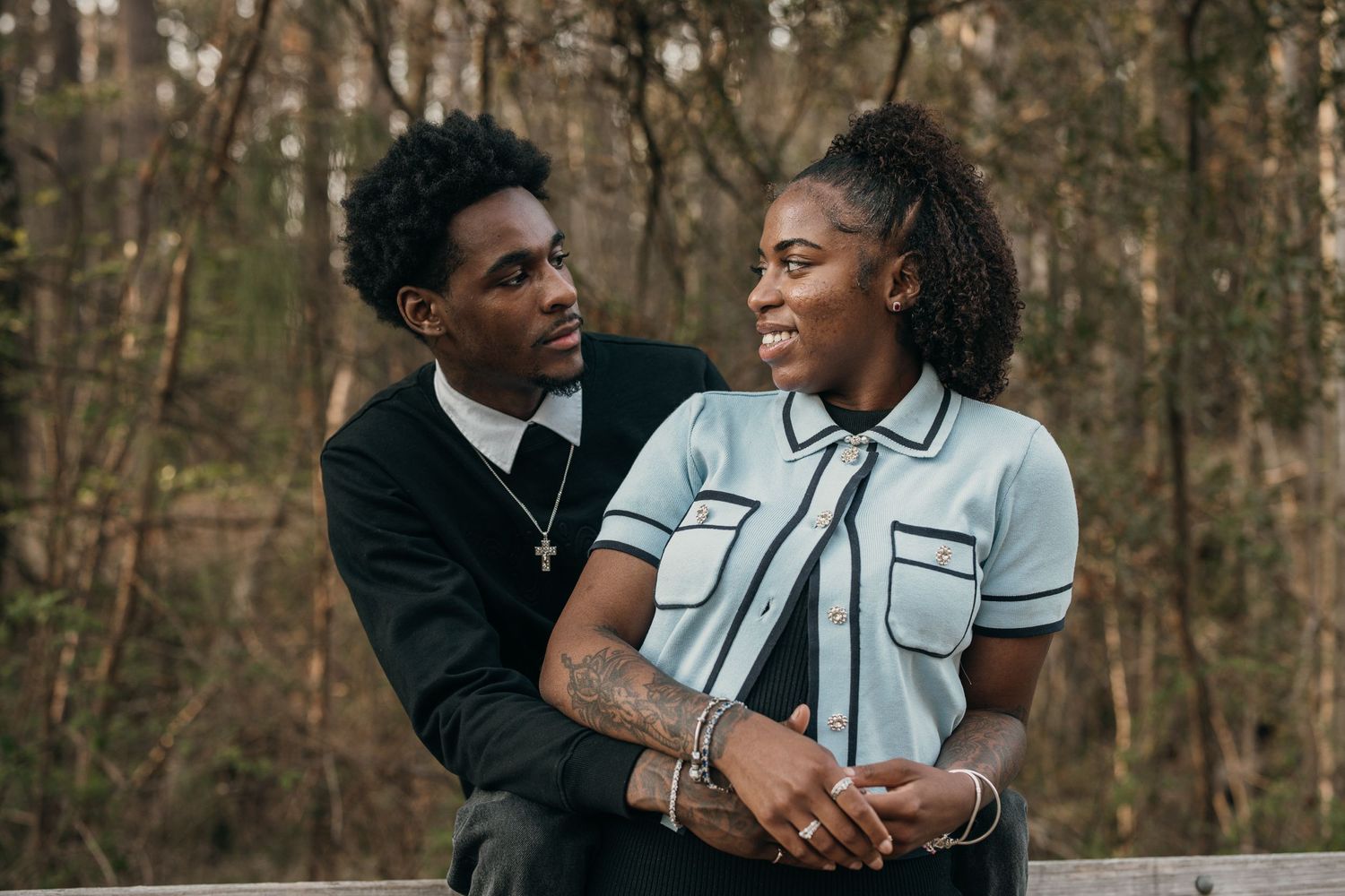 young black couple standing close, smiling at each other at Suwanee park, candid couples photography in Atlanta