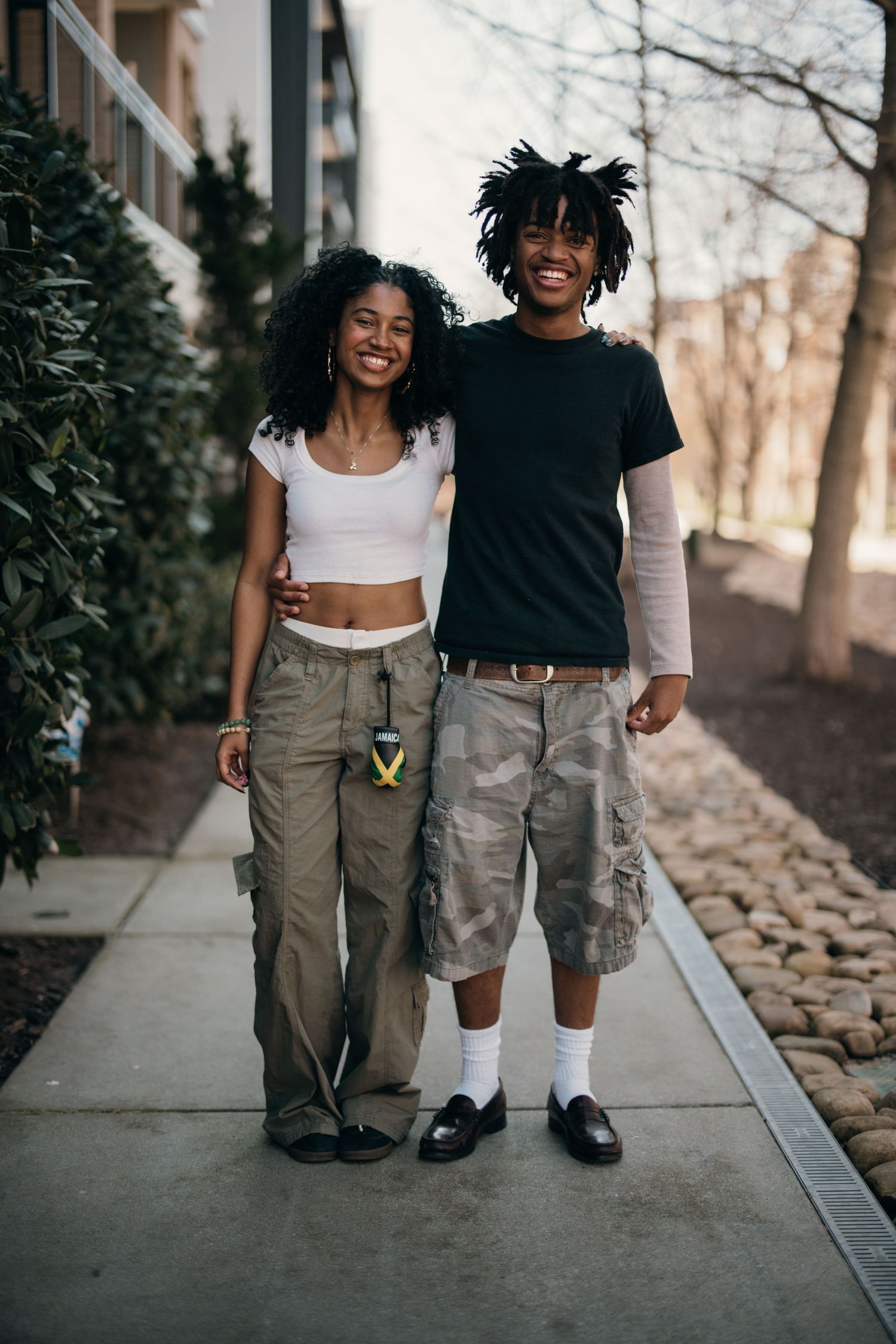 couples posing arm in arm on atlantic station sidewalk, relaxed, candid atlanta engagement photography