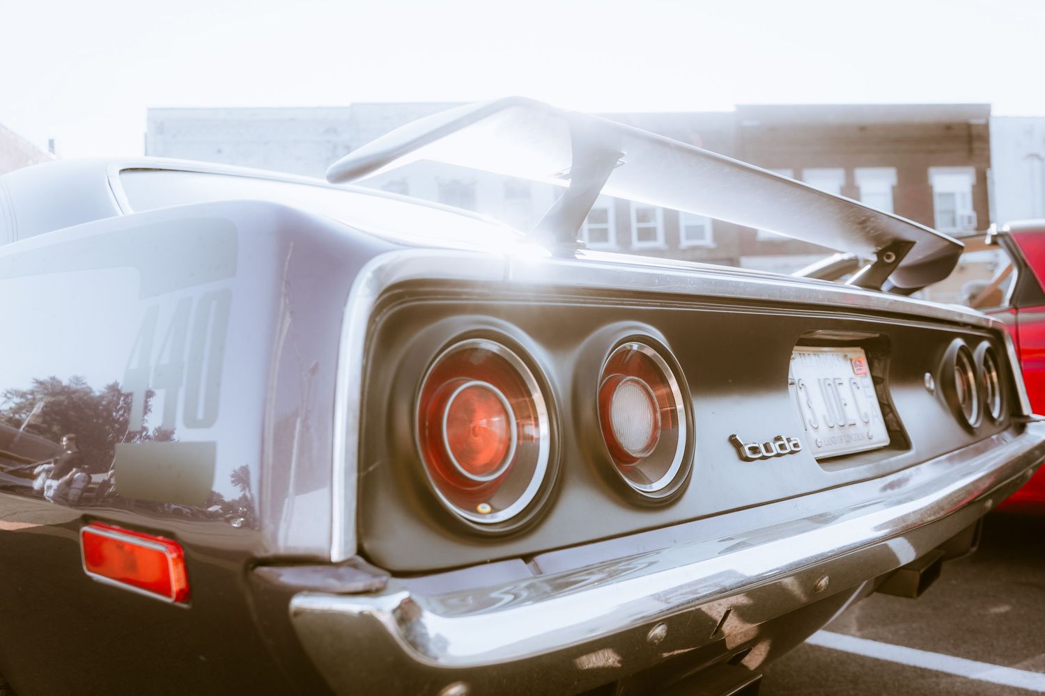 Close-up rear view of a classic Chevrolet Impala tail lights and chrome bumper.