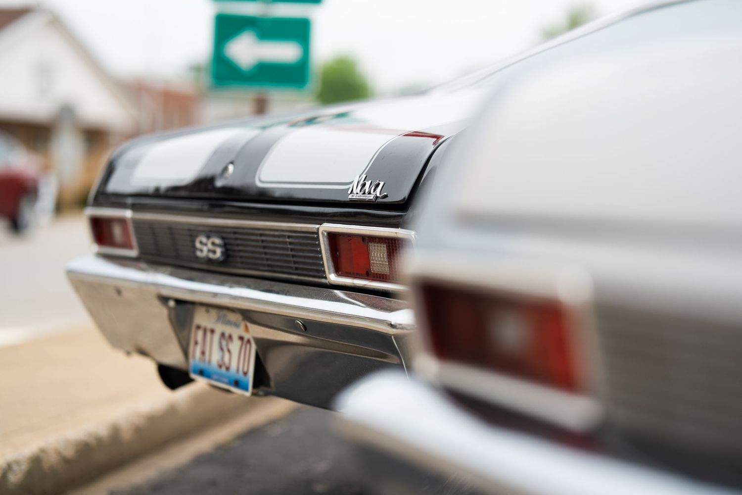 Classic vintage car tail lights and chrome trim details in soft focus.