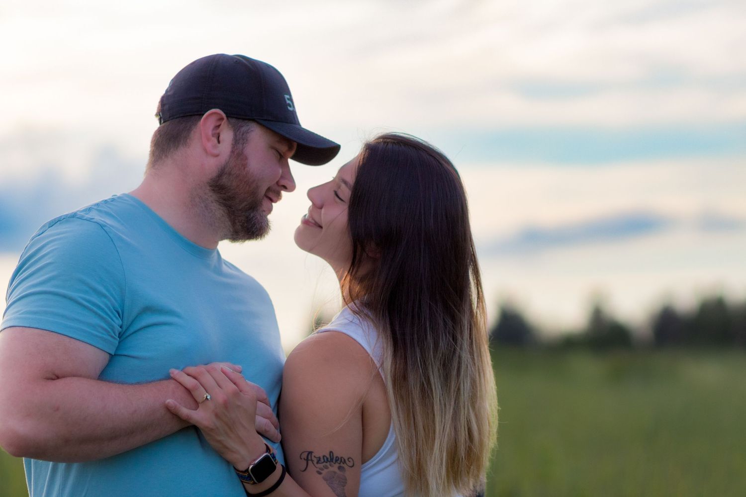 A photo collage captures close-up intimate moments between a couple posing together outdoors in turquoise clothing.