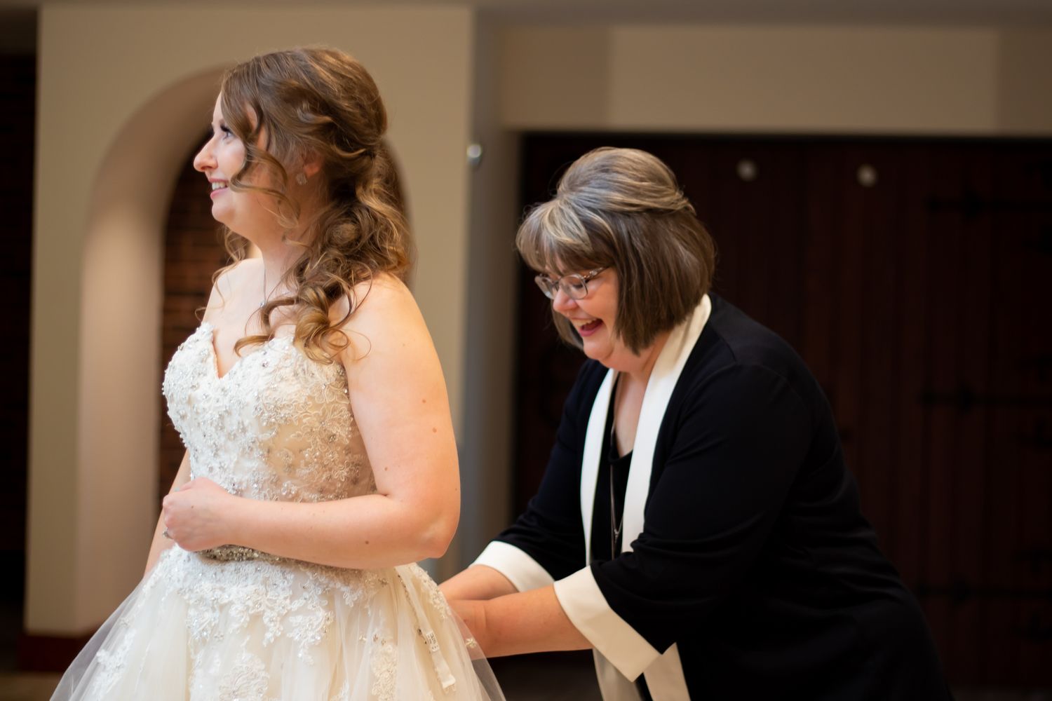 Wedding preparation moments captured in warm indoor lighting.