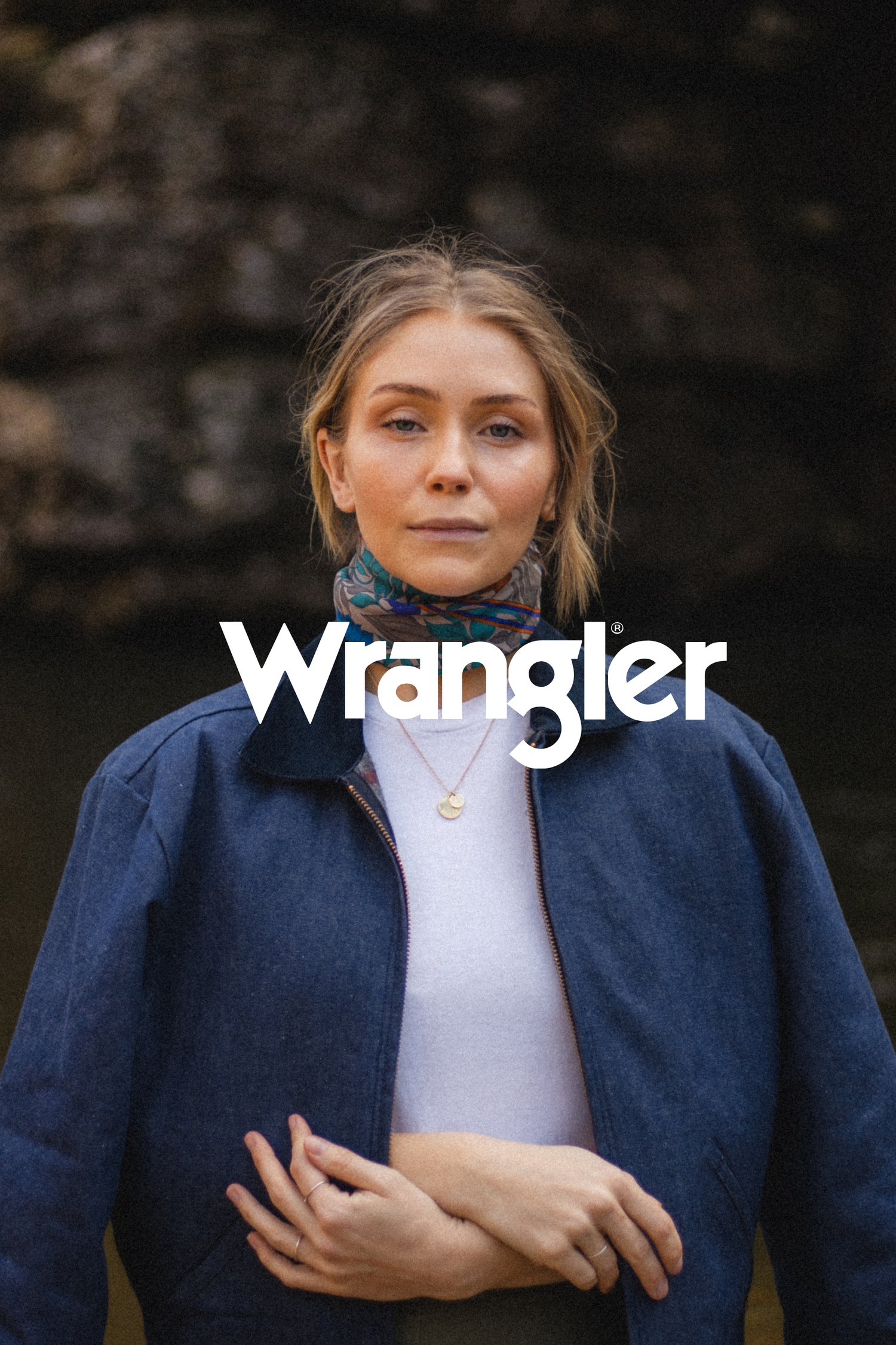 Advertisement showing person in denim jacket with Wrangler logo overlay.