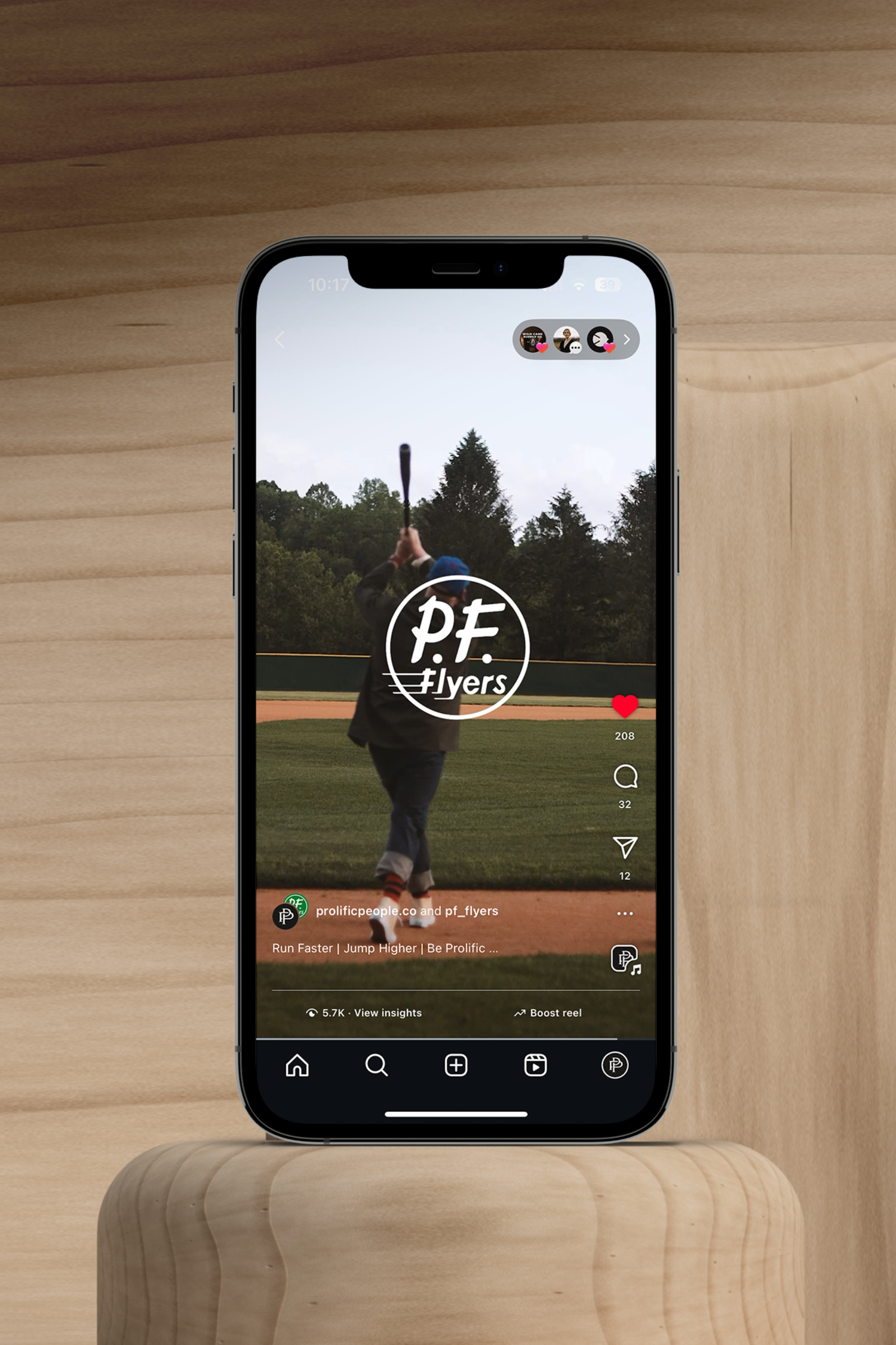 iPhone displaying PE Flyers social media content on wooden surface.