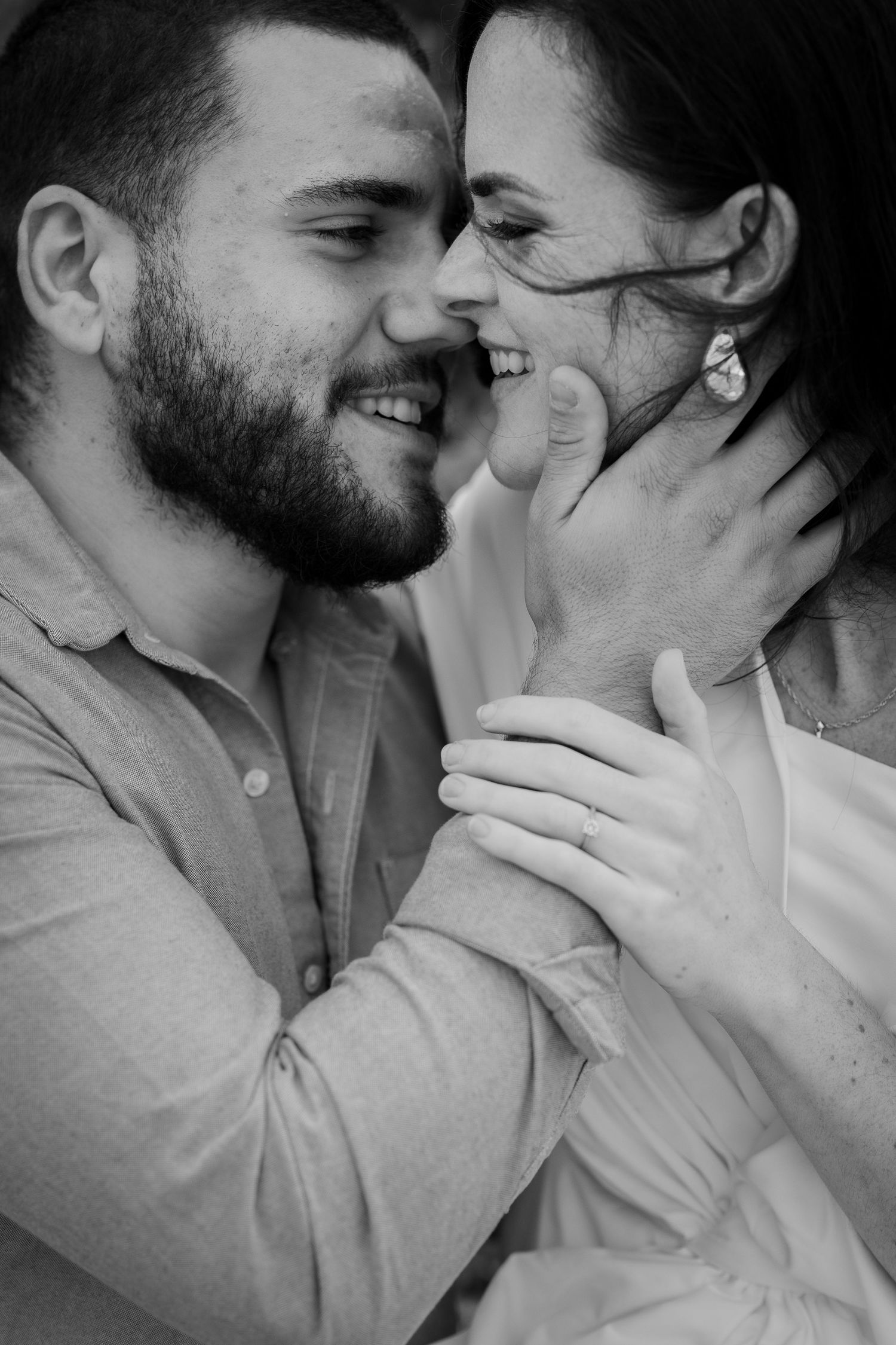 Engaged couple smiling and holding hands during their engagement photo session at perrys paddock celebrating their love