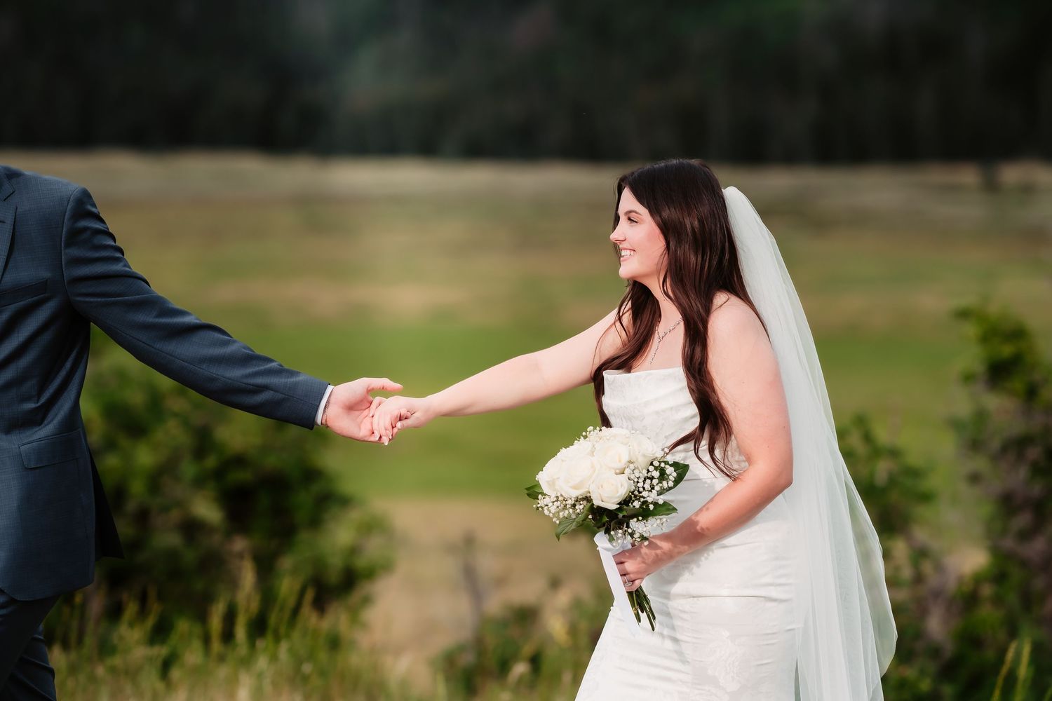 Scenic lakeside wedding portraits with mountain landscape in background.