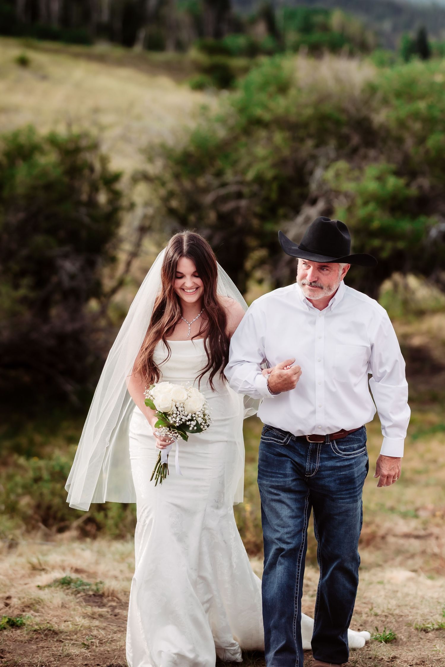 A joyful walk down a mountain path during a wedding ceremony.