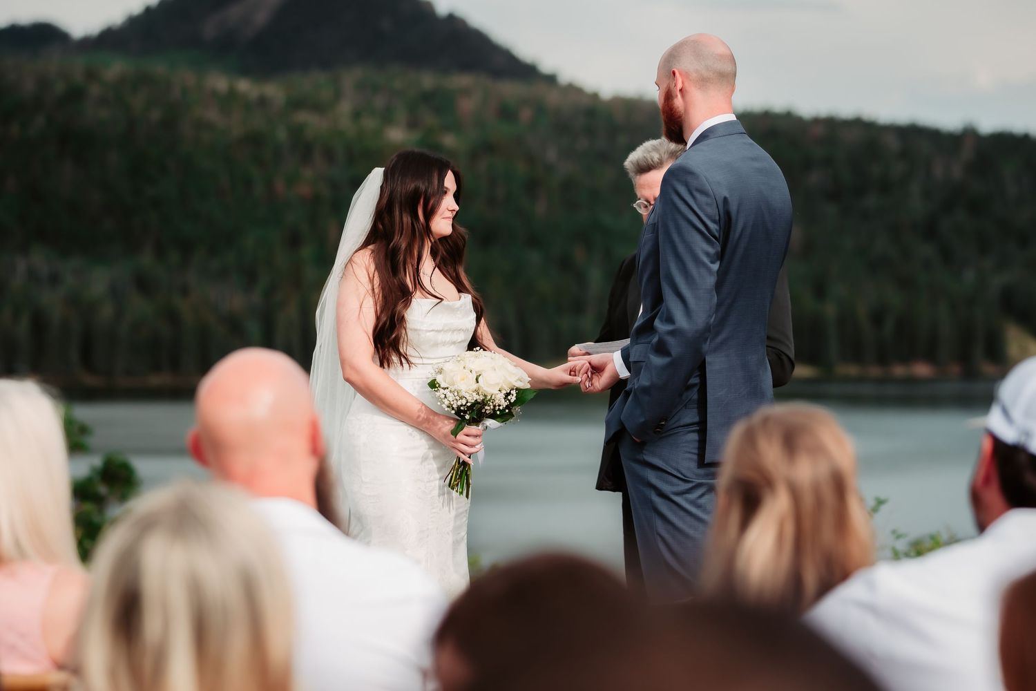 Outdoor wedding ceremony overlooking scenic mountain lake.