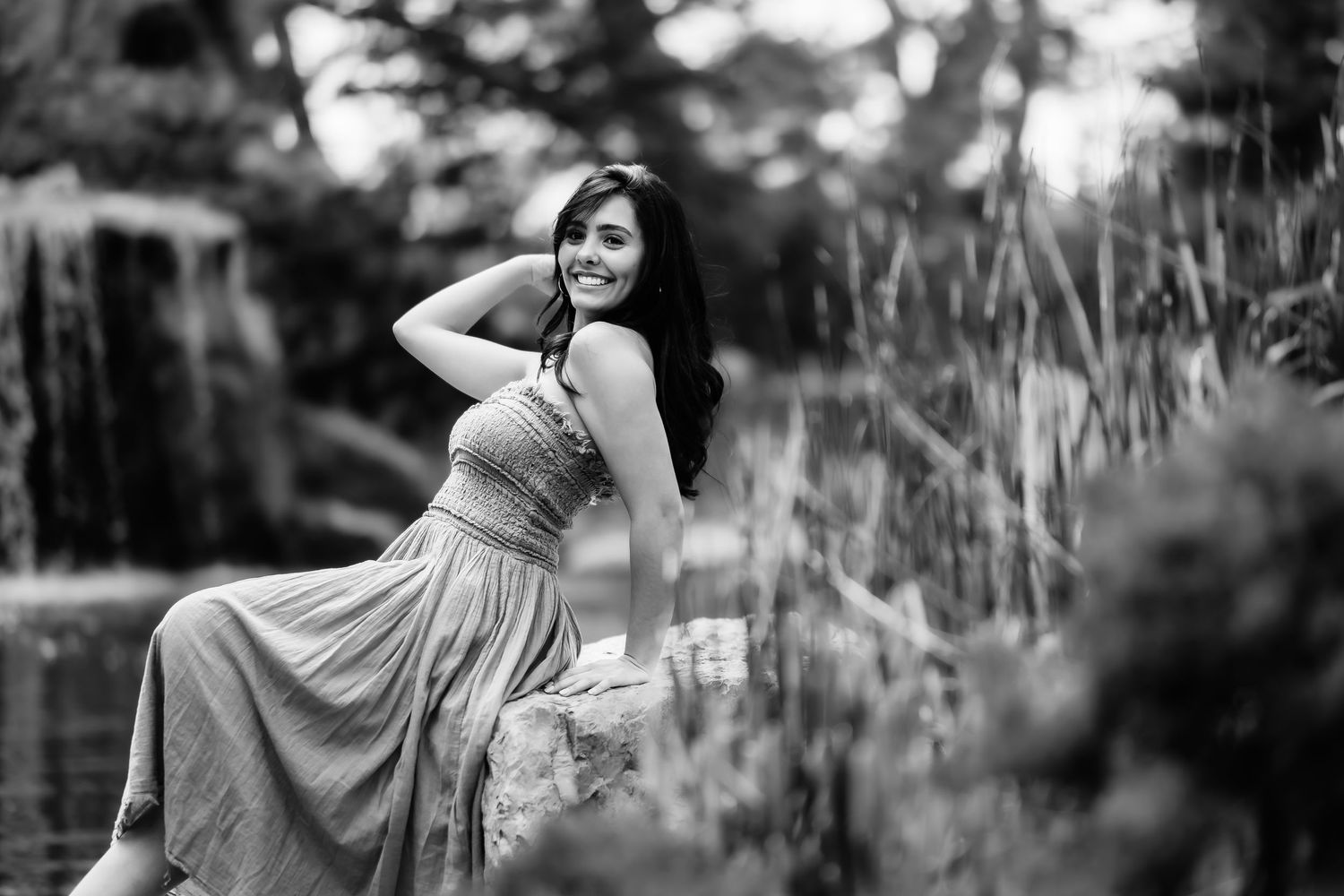Dreamy black and white portrait in a natural setting with tall grass.