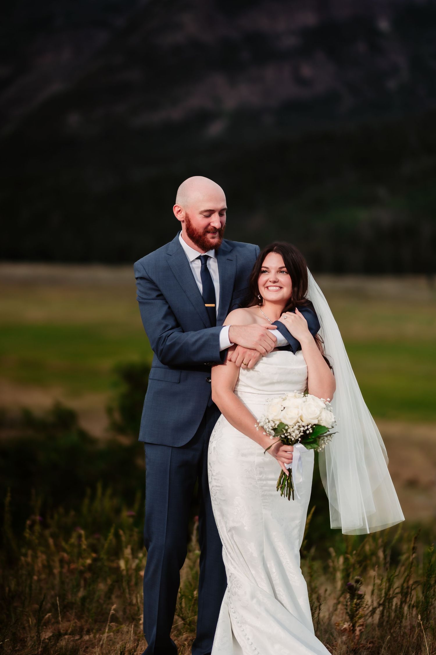 Intimate wedding portraits in a scenic mountain setting.