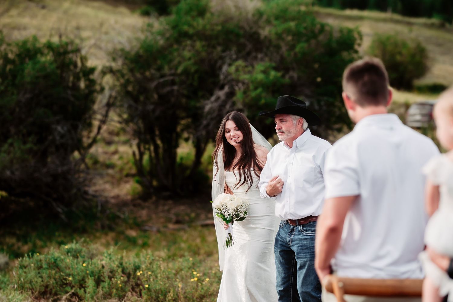 Candid wedding moments captured in a rustic outdoor setting with natural lighting.