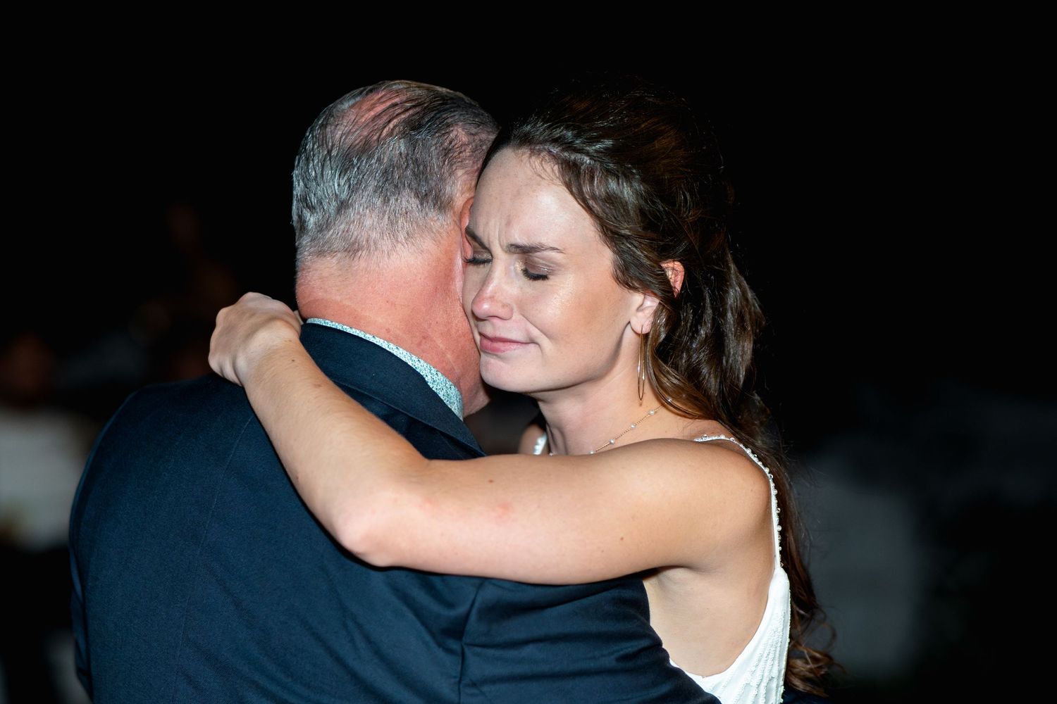 Intimate dance moment captured during evening wedding reception.