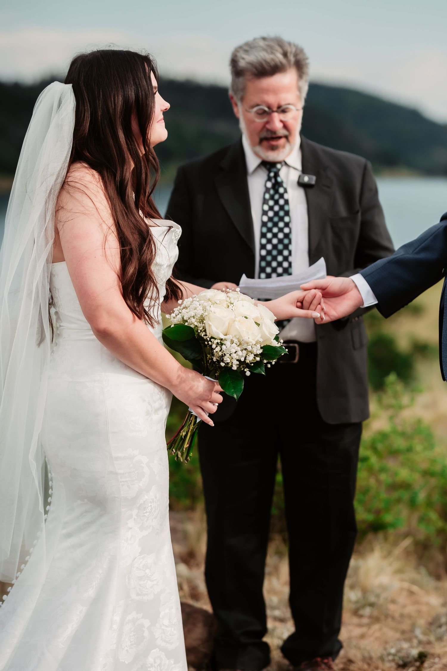 Series of emotional close-up shots during a wedding ceremony showing tender moments and ring exchanges by the waterfront.
