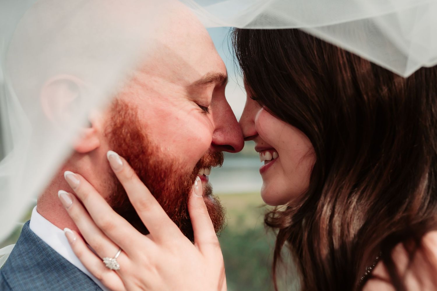 Romantic close-up shot of newlyweds sharing an intimate moment.