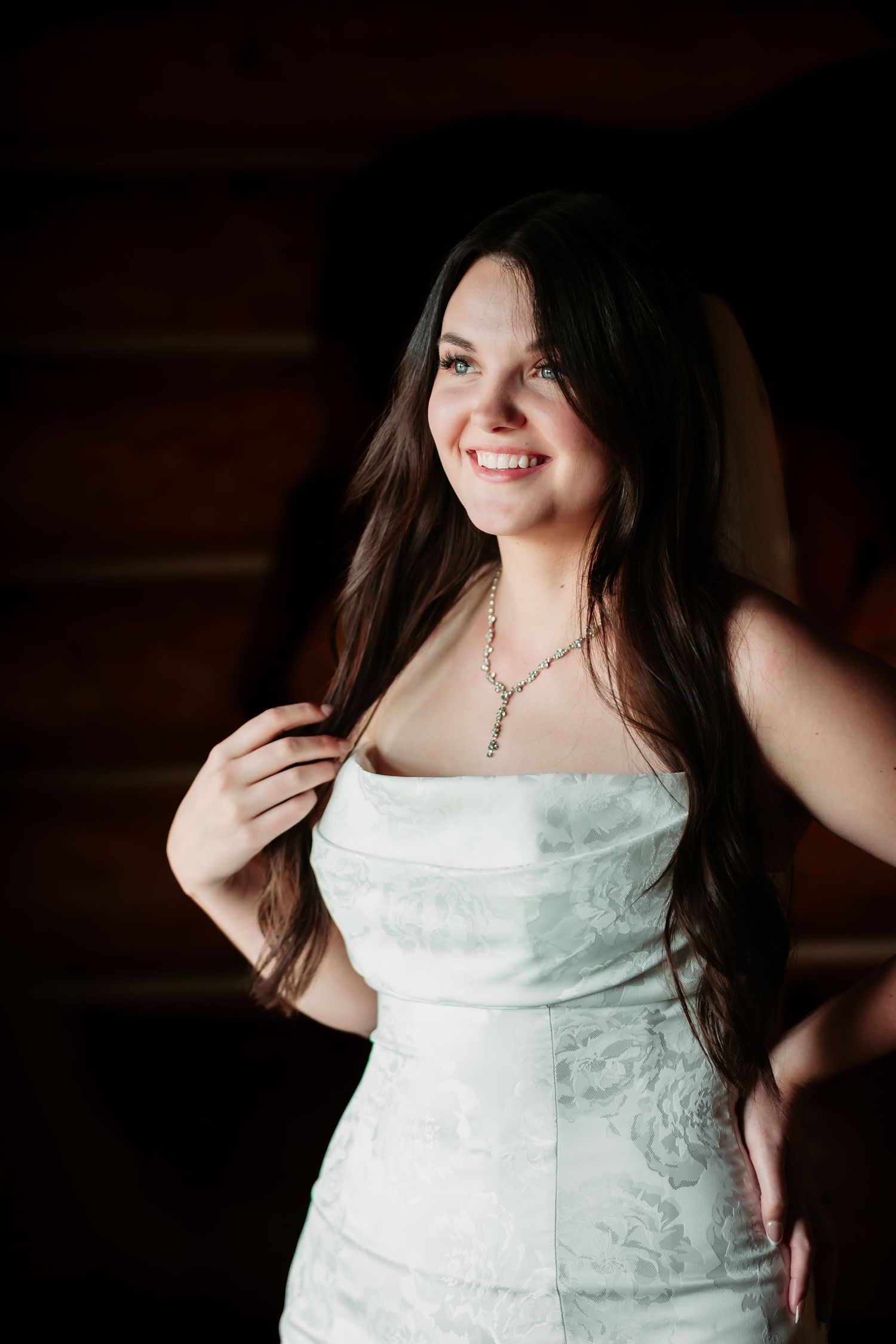 A series of portraits showing a bride in a white strapless wedding dress against a dark background.