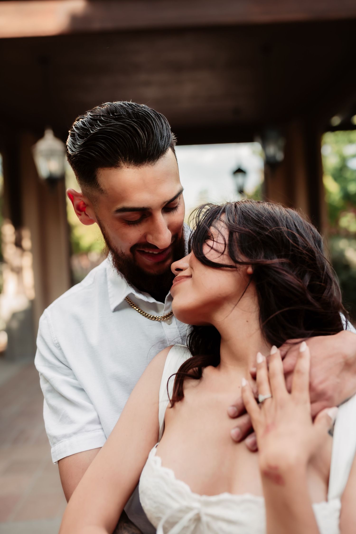 An intimate close-up series captures tender moments between a couple dressed in white.