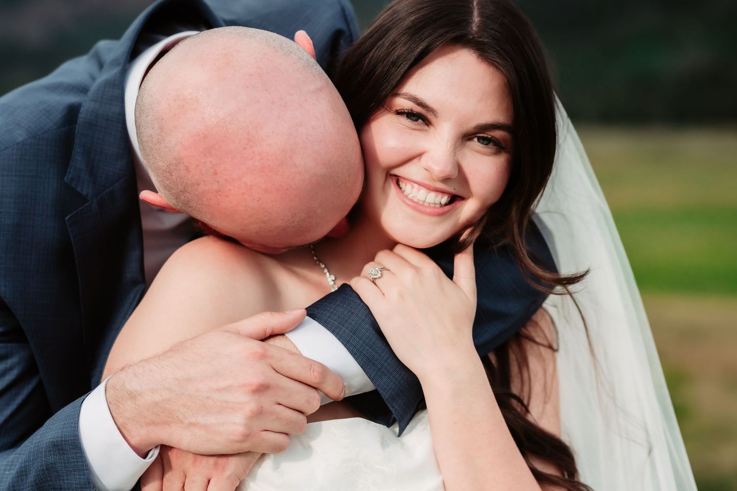 Wedding couple share intimate moments against mountain backdrop in romantic photo series.