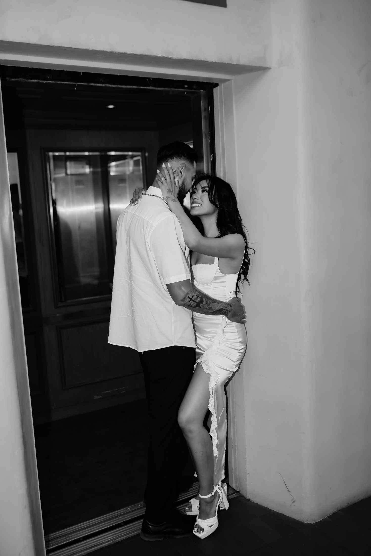 Black and white photos showing intimate couple moments in a hallway interior.