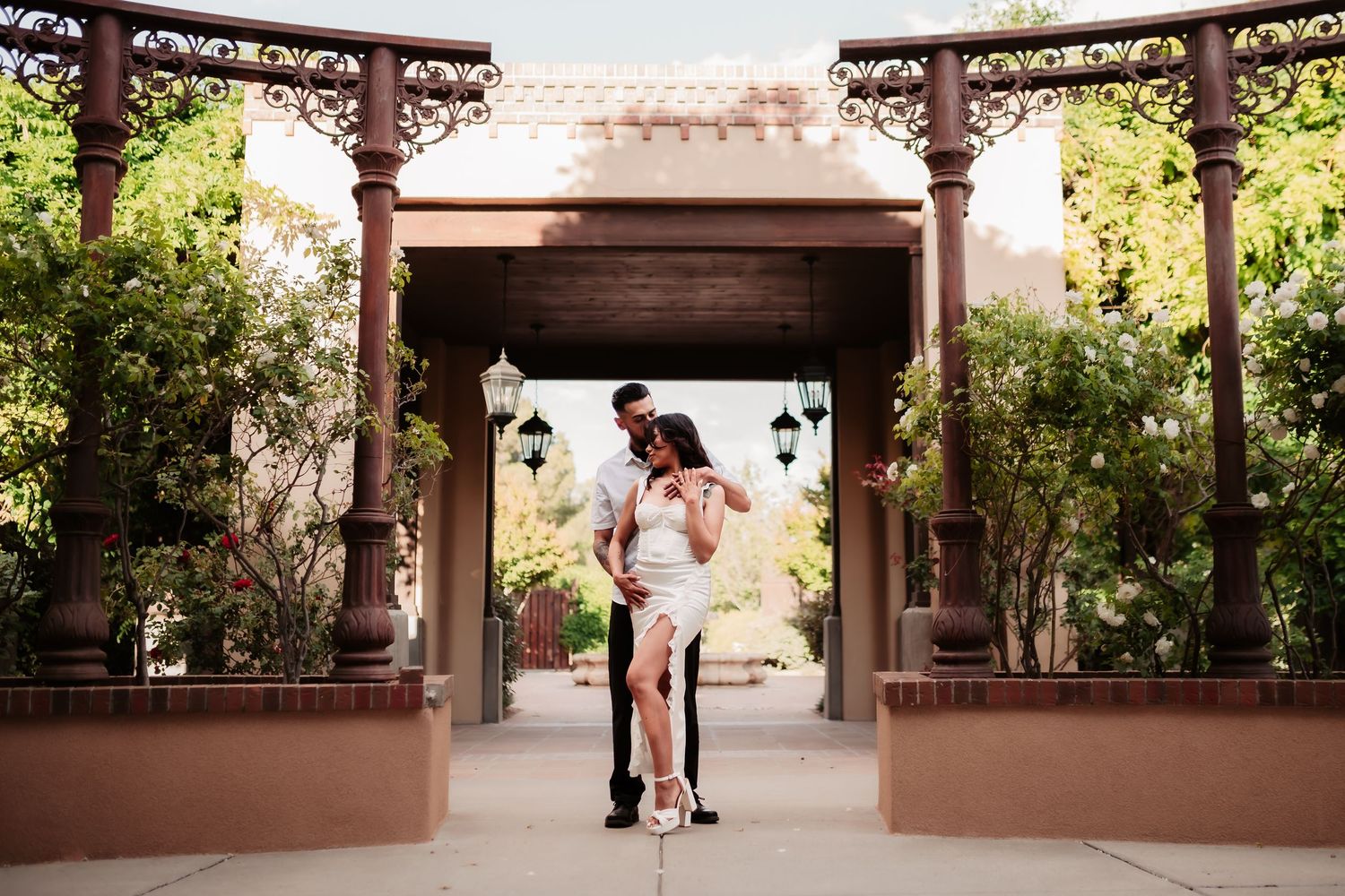 Wide architectural shots of a covered pergola area where a couple shares intimate moments.