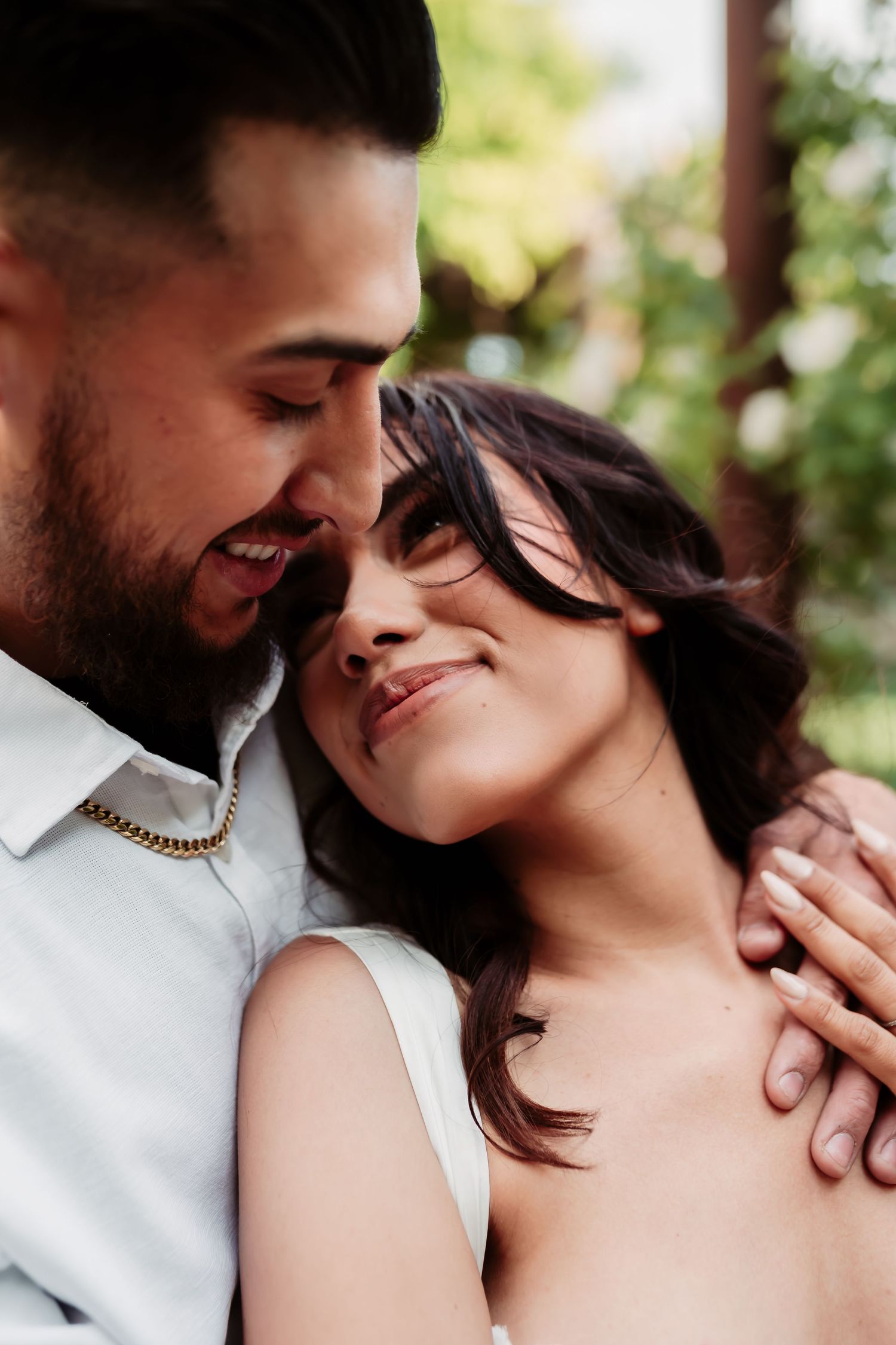 Tender moment between couple sharing intimate embrace during romantic photoshoot.