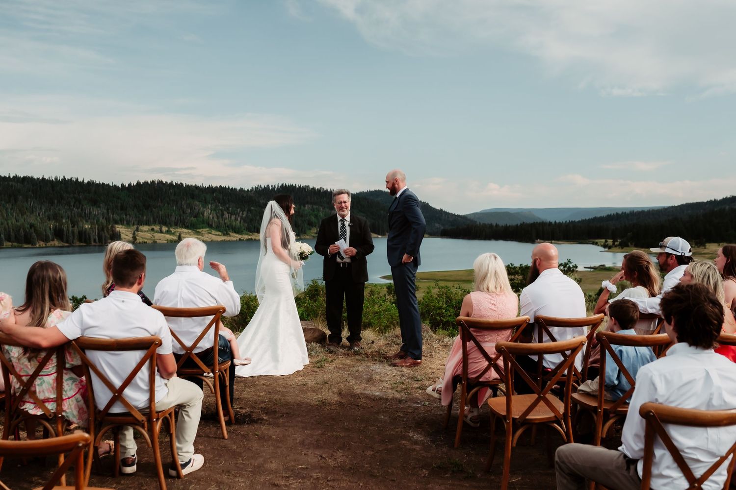 An intimate outdoor wedding ceremony overlooking a serene mountain lake.