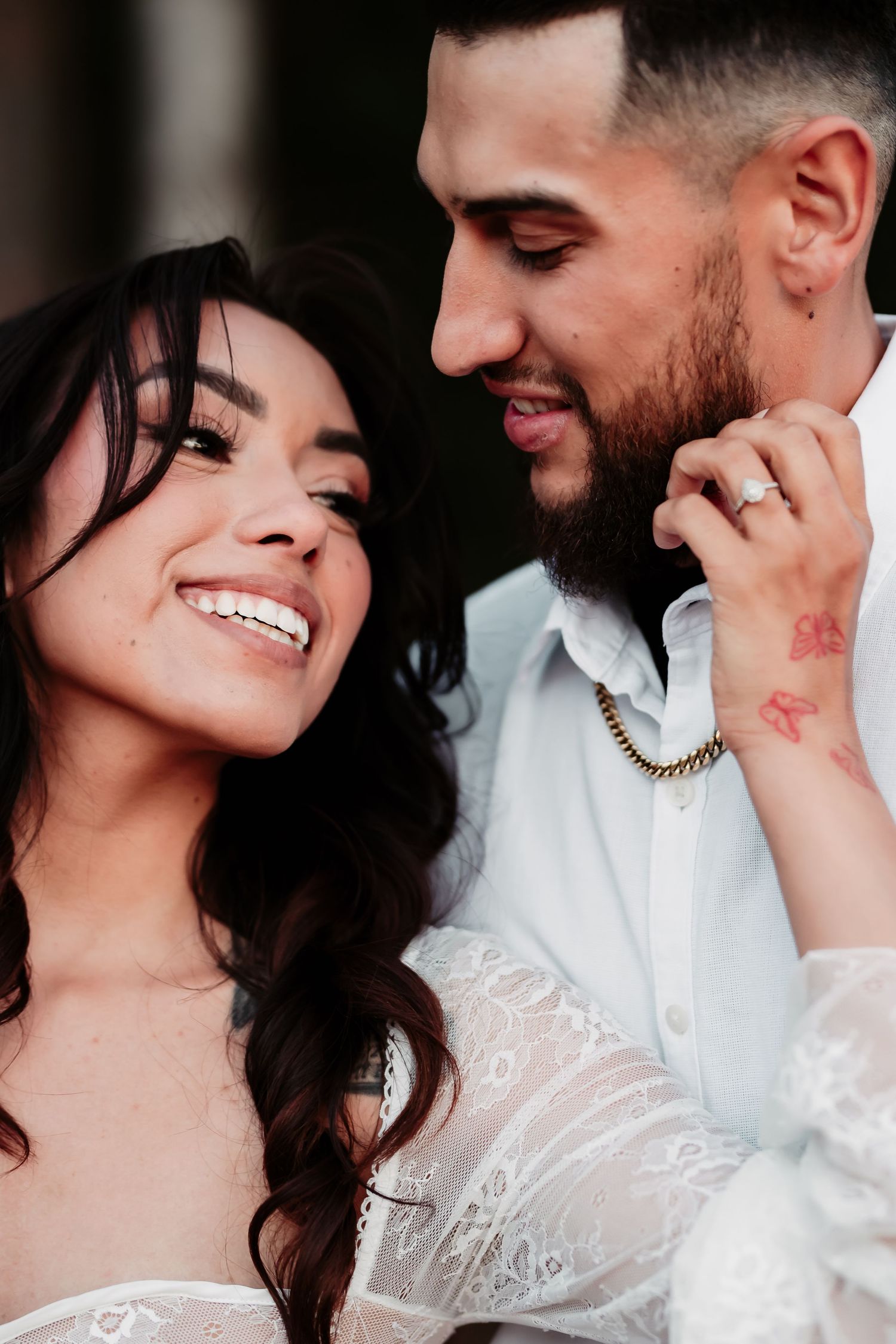 Intimate close-up of a couple sharing a tender moment with warm lighting and joyful expressions.