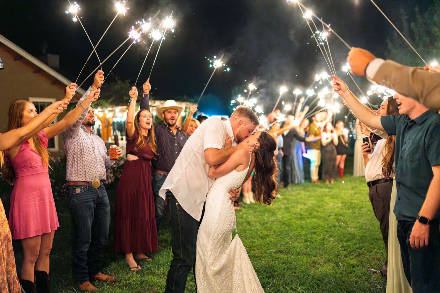 Romantic sparkler exit with guests creating a tunnel of light for the newlyweds.