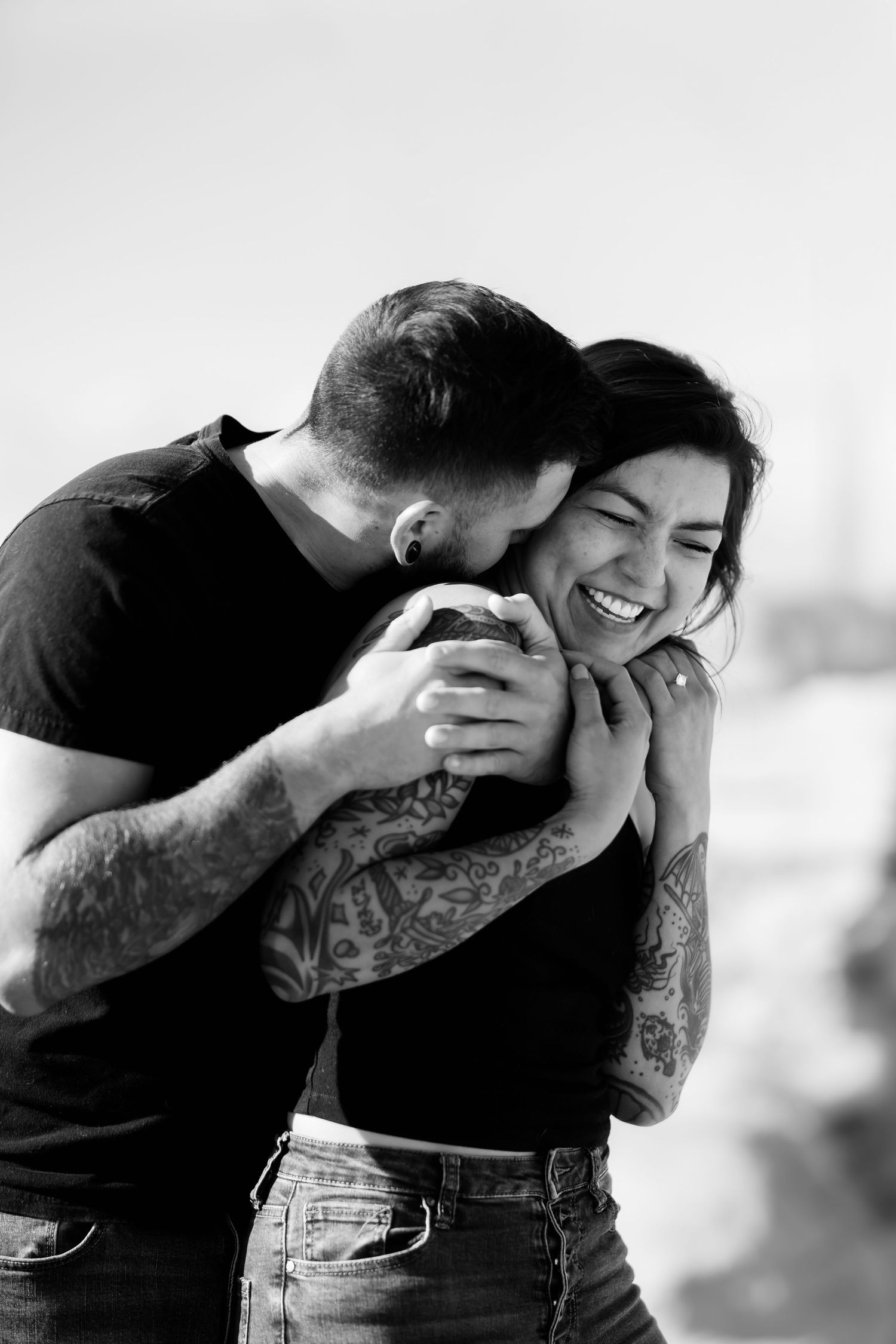 Intimate black and white portrait of couple sharing joyful moment.
