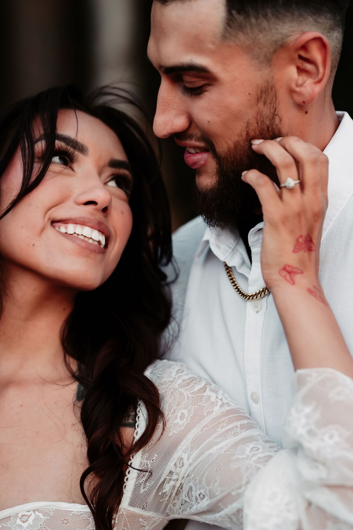A romantic series of wedding photos showing a couple embracing in tender moments wearing white formal attire.