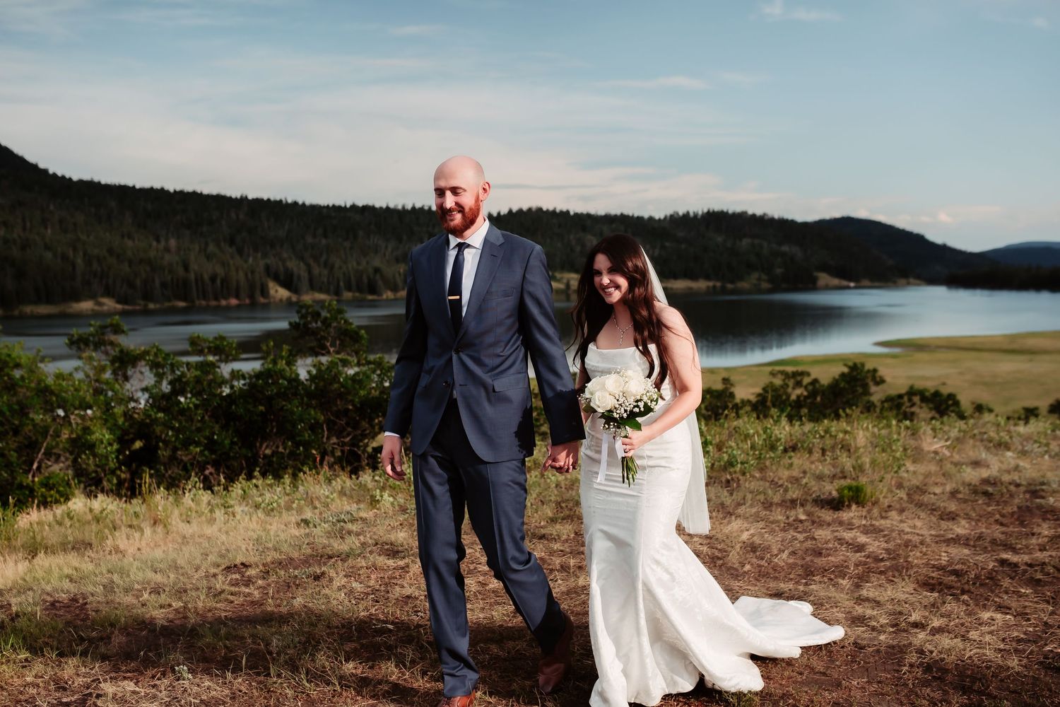 A scenic mountain lake creates a perfect backdrop for wedding portraits.