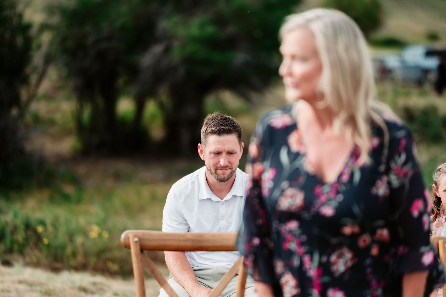Wedding guests enjoying an outdoor gathering with mountain scenery.