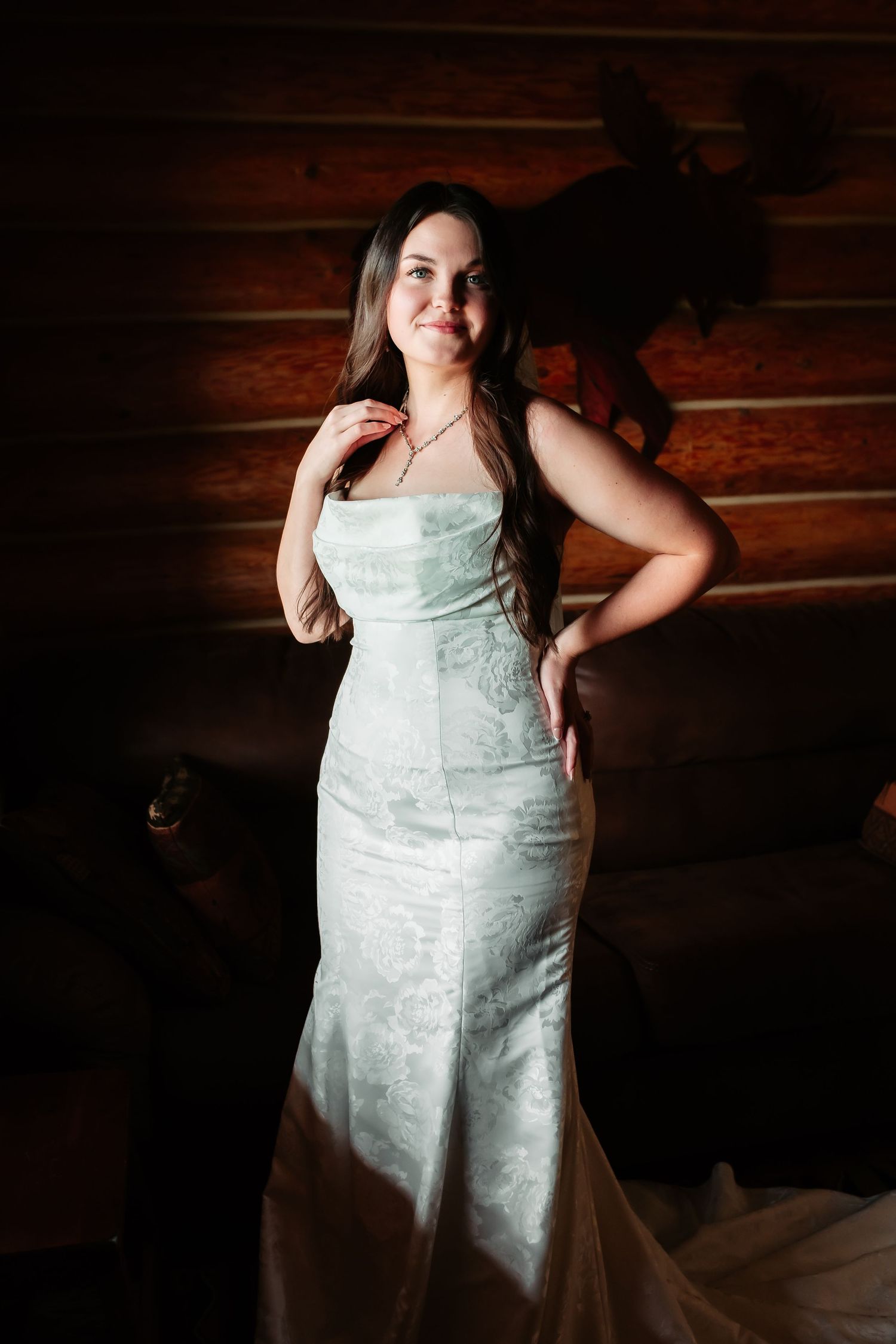 A sequence of dramatic portrait shots featuring someone in a white wedding dress posing against rustic wooden walls.