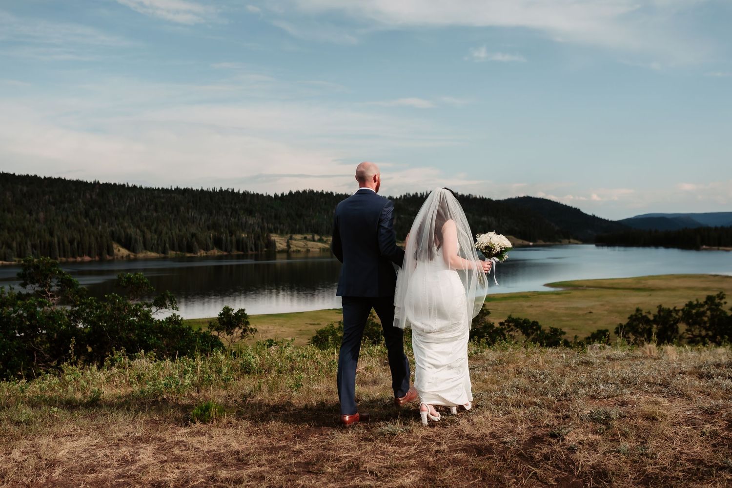 Scenic mountain lake provides stunning backdrop for outdoor wedding ceremony.