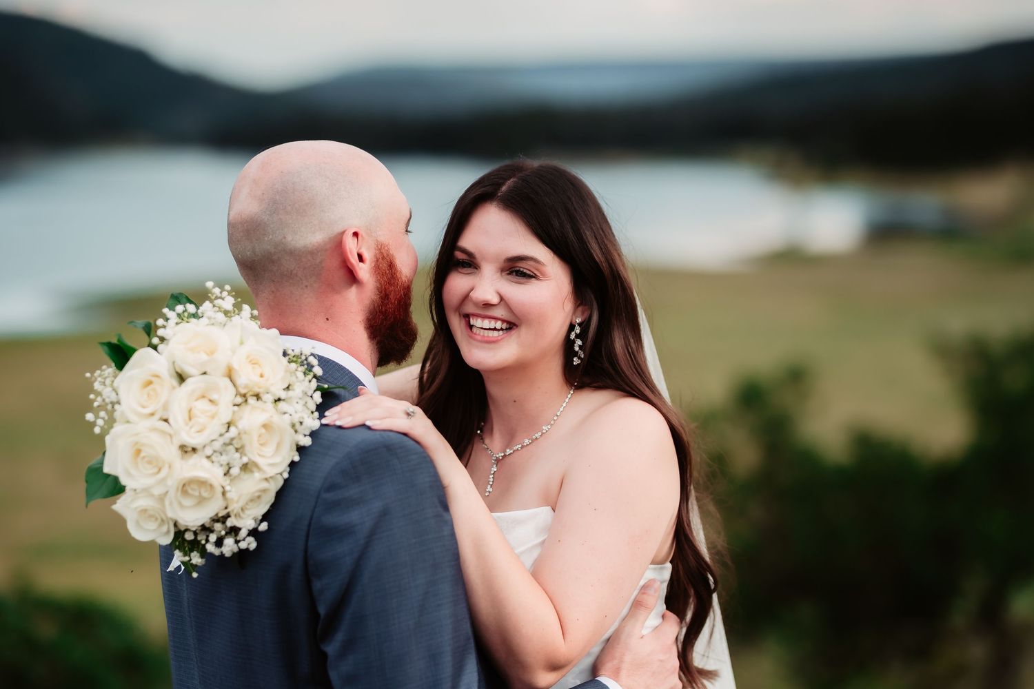 Joyful candid moments between a couple during their waterfront wedding ceremony.