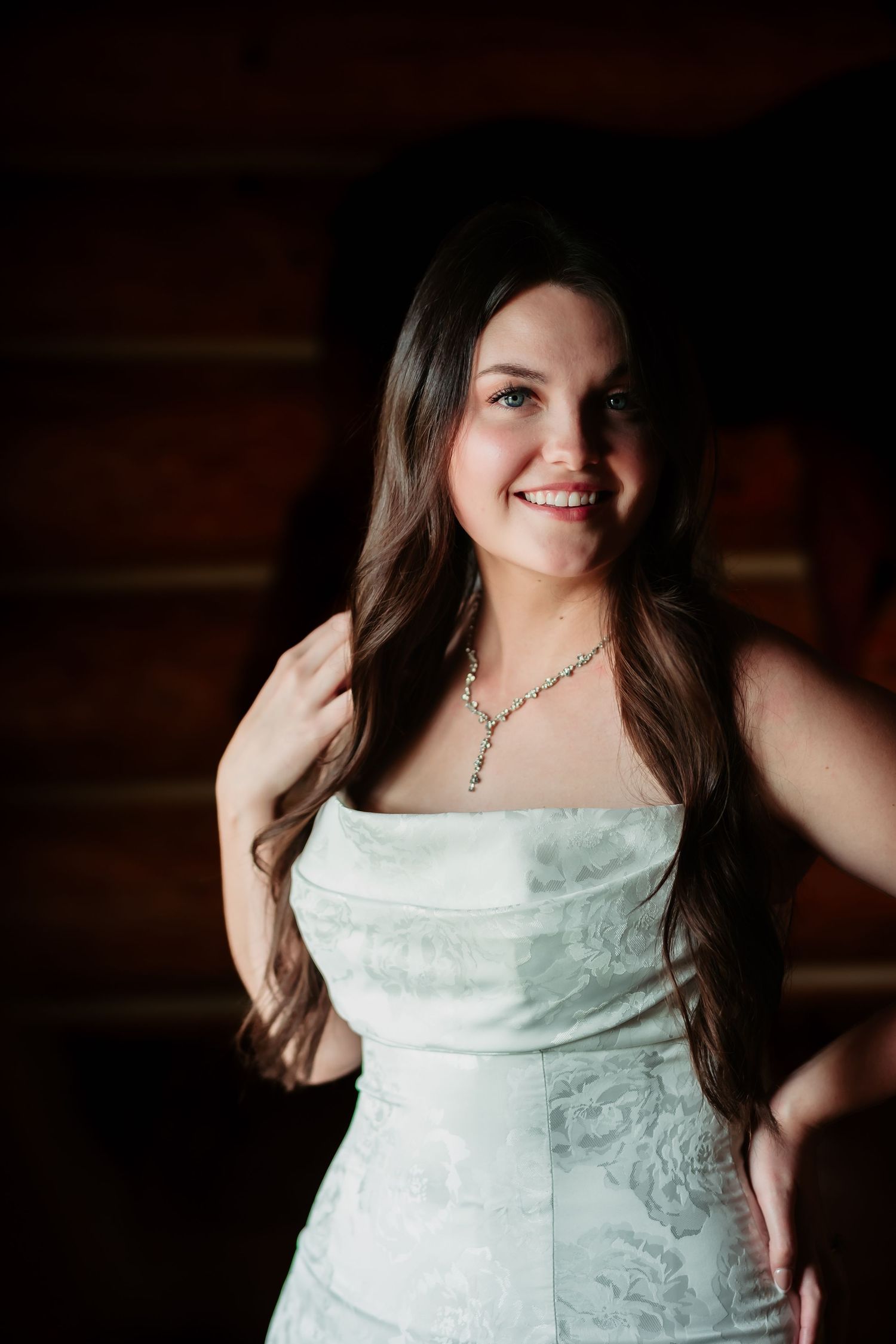 White lace or embroidered dress shown in various close-up detail shots against dark background.