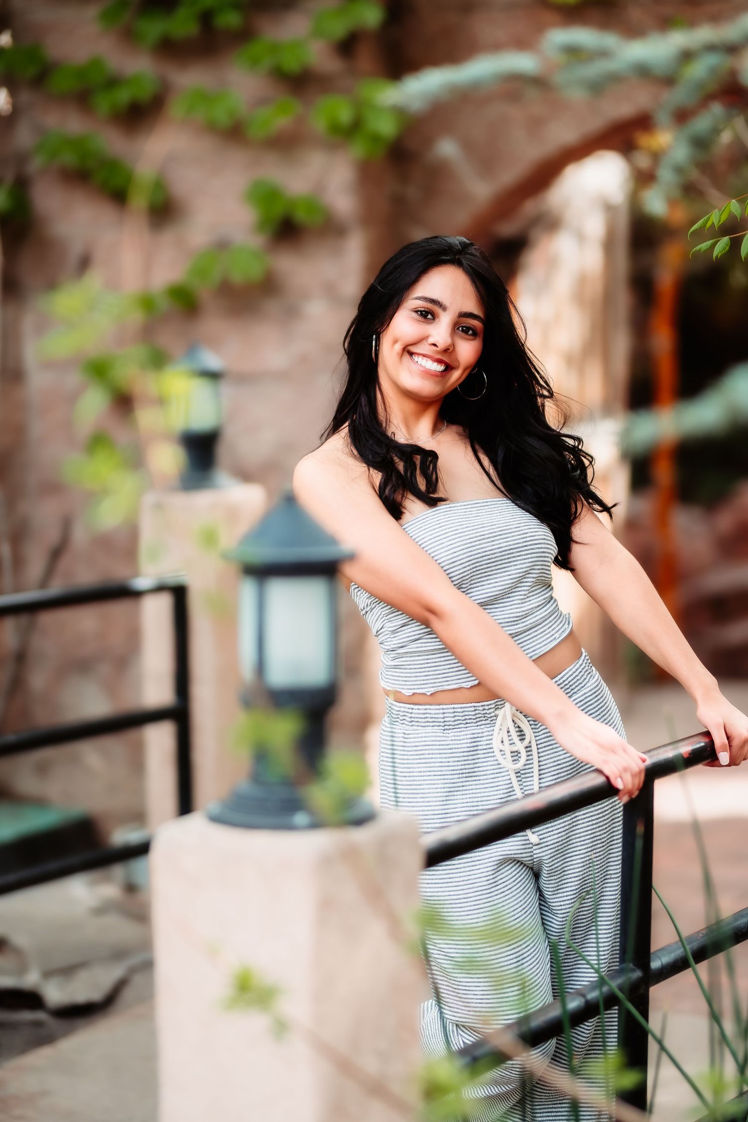 Casual portrait on stairs wearing grey matching set outfit.