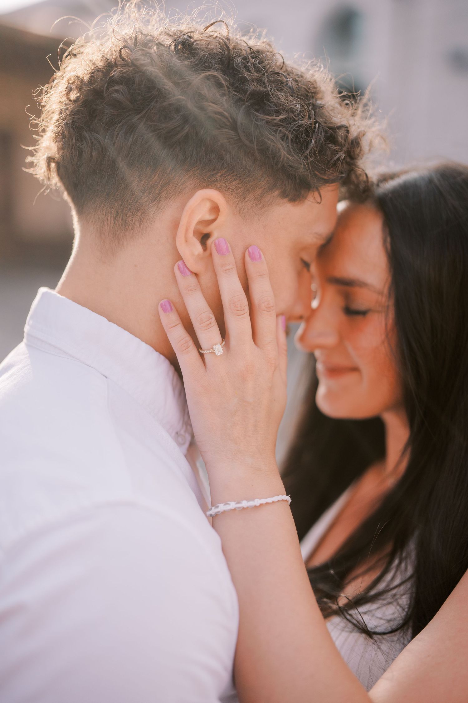 Intimate couple sharing a tender moment as she gently touches his face with her hand.
