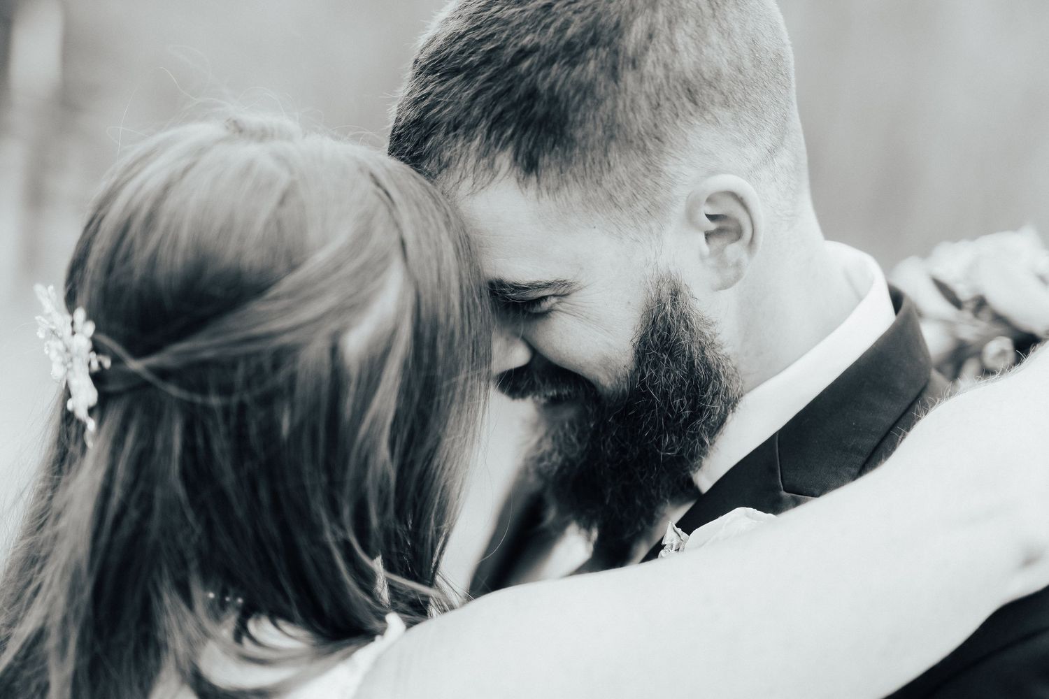 Close-up black and white wedding portrait capturing an intimate moment.