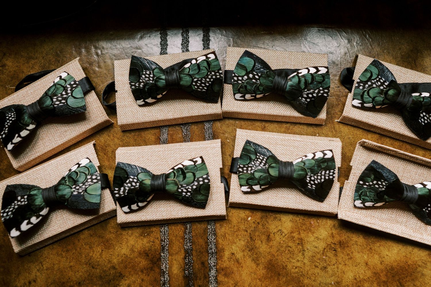 A row of printed circuit boards laid out in a line on a rustic wooden surface.