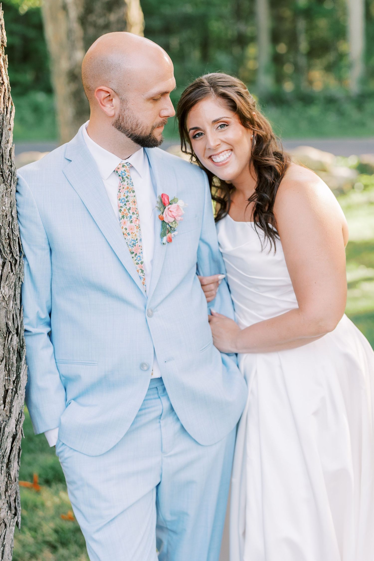 Light and airy wedding portrait against natural woodland background.