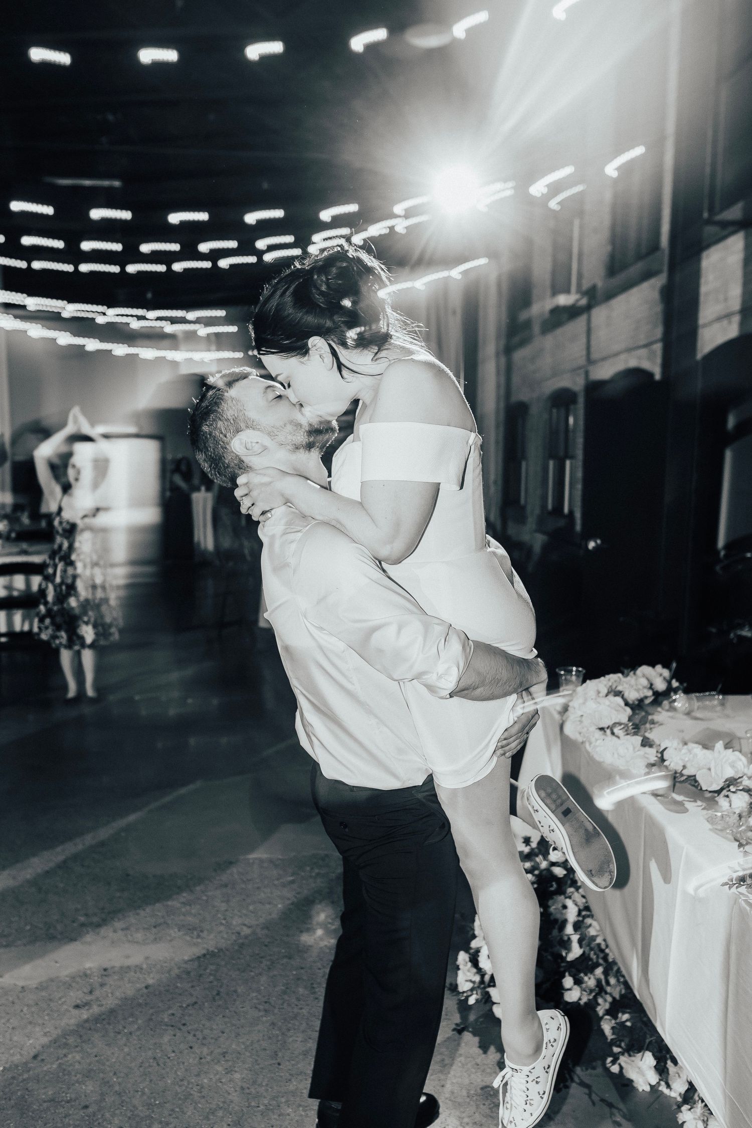 Black and white photo of romantic dance moment at wedding reception.