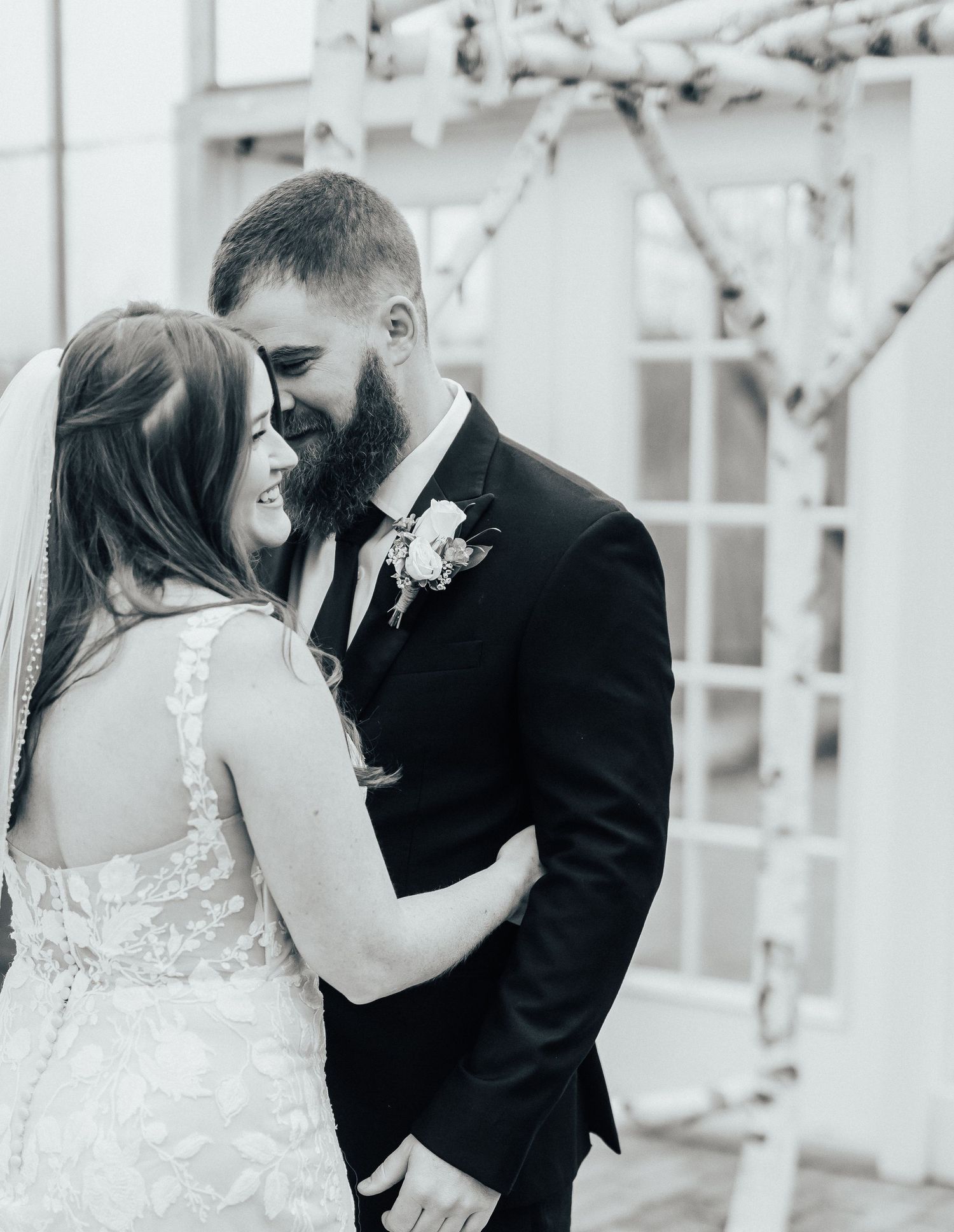 Intimate black and white portrait of happy newlyweds sharing a romantic moment together.