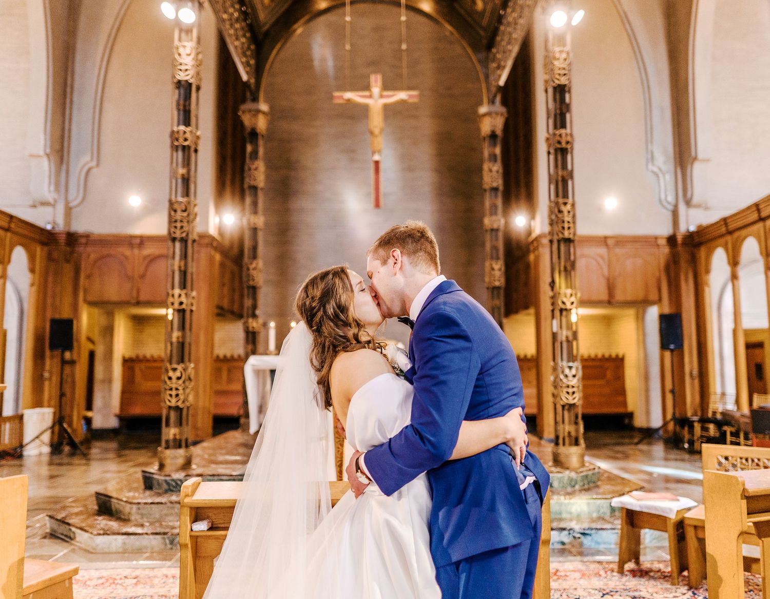 A romantic wedding ceremony in a beautiful church sanctuary with warm lighting and wooden pews.