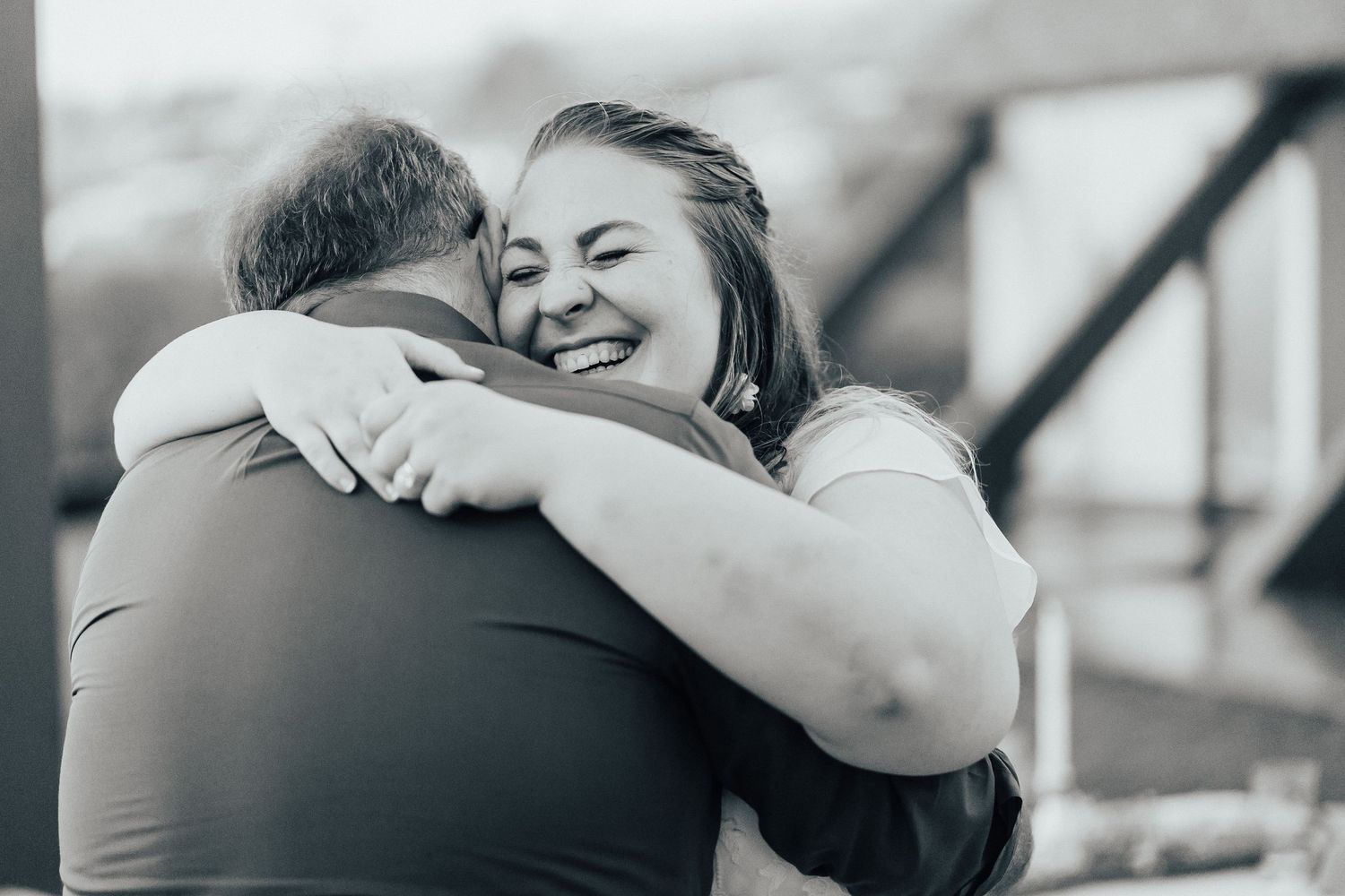 Two people sharing an emotional embrace during what appears to be a special moment.