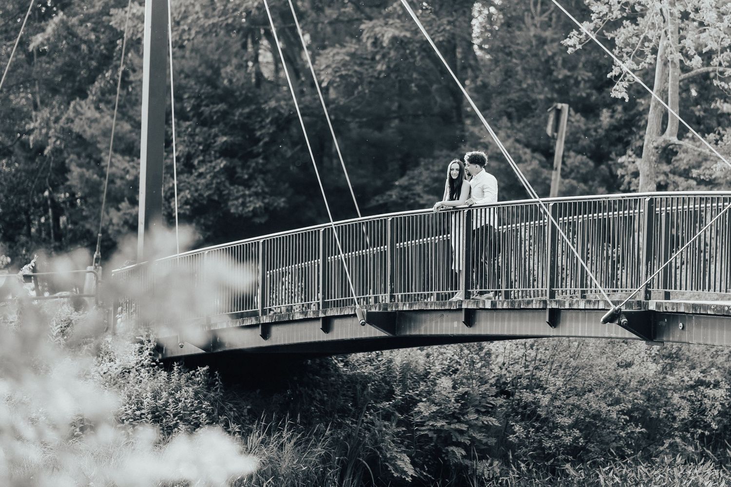 A scenic pedestrian bridge stretches across a misty landscape.