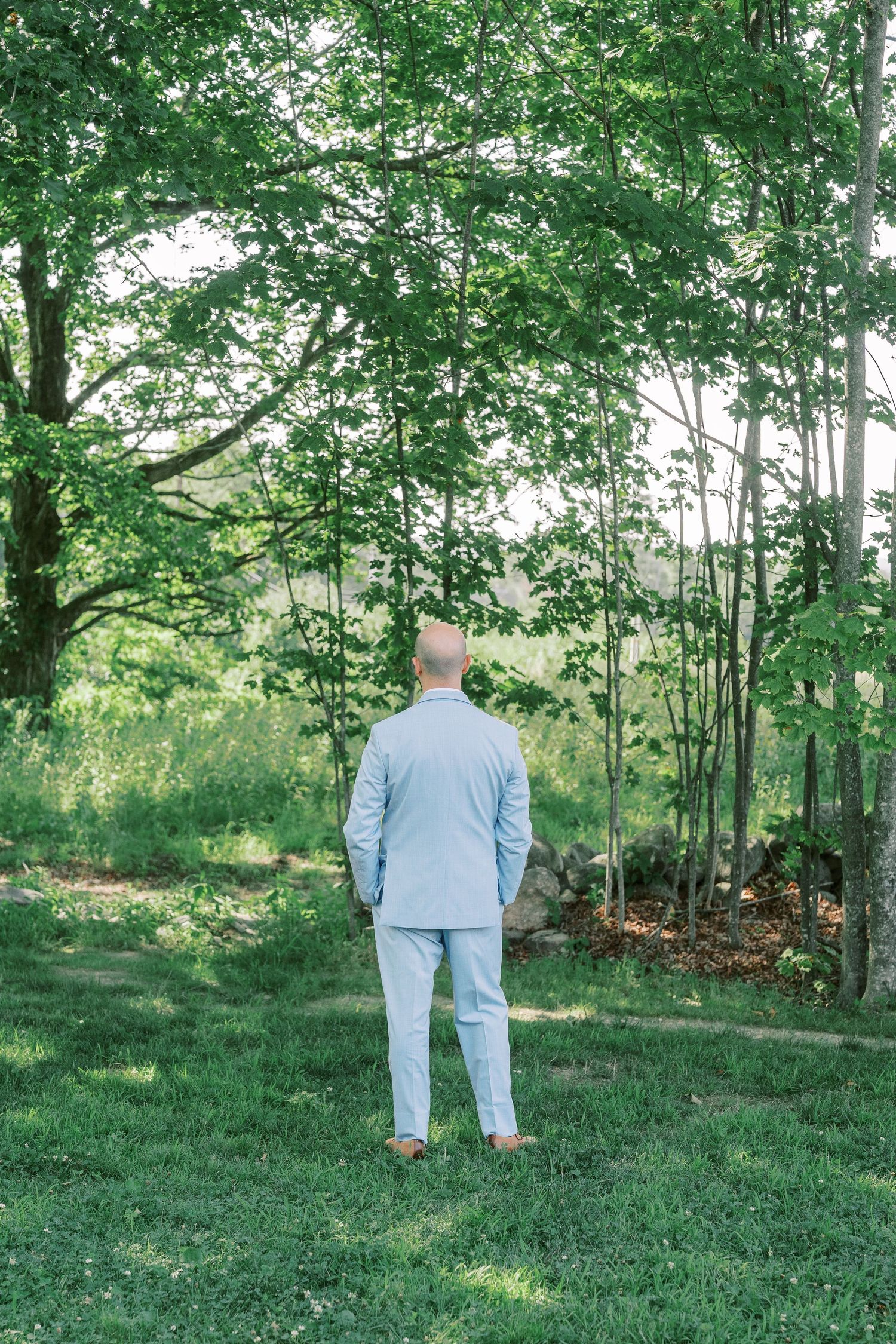 A wedding scene in a lush green forest setting with soft natural lighting.