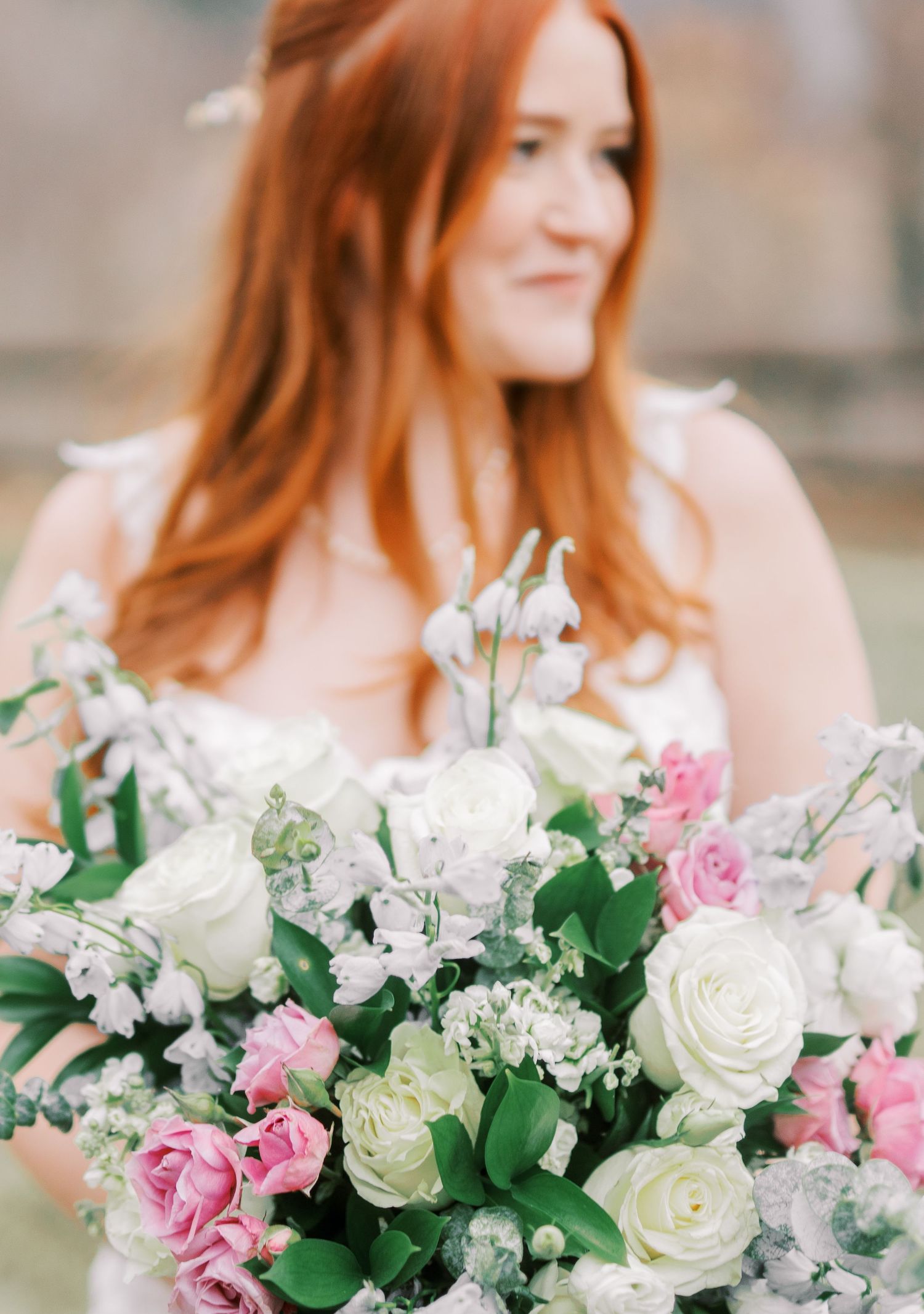 Beautiful bridal bouquet with pink and white roses, paired with delicate greenery.