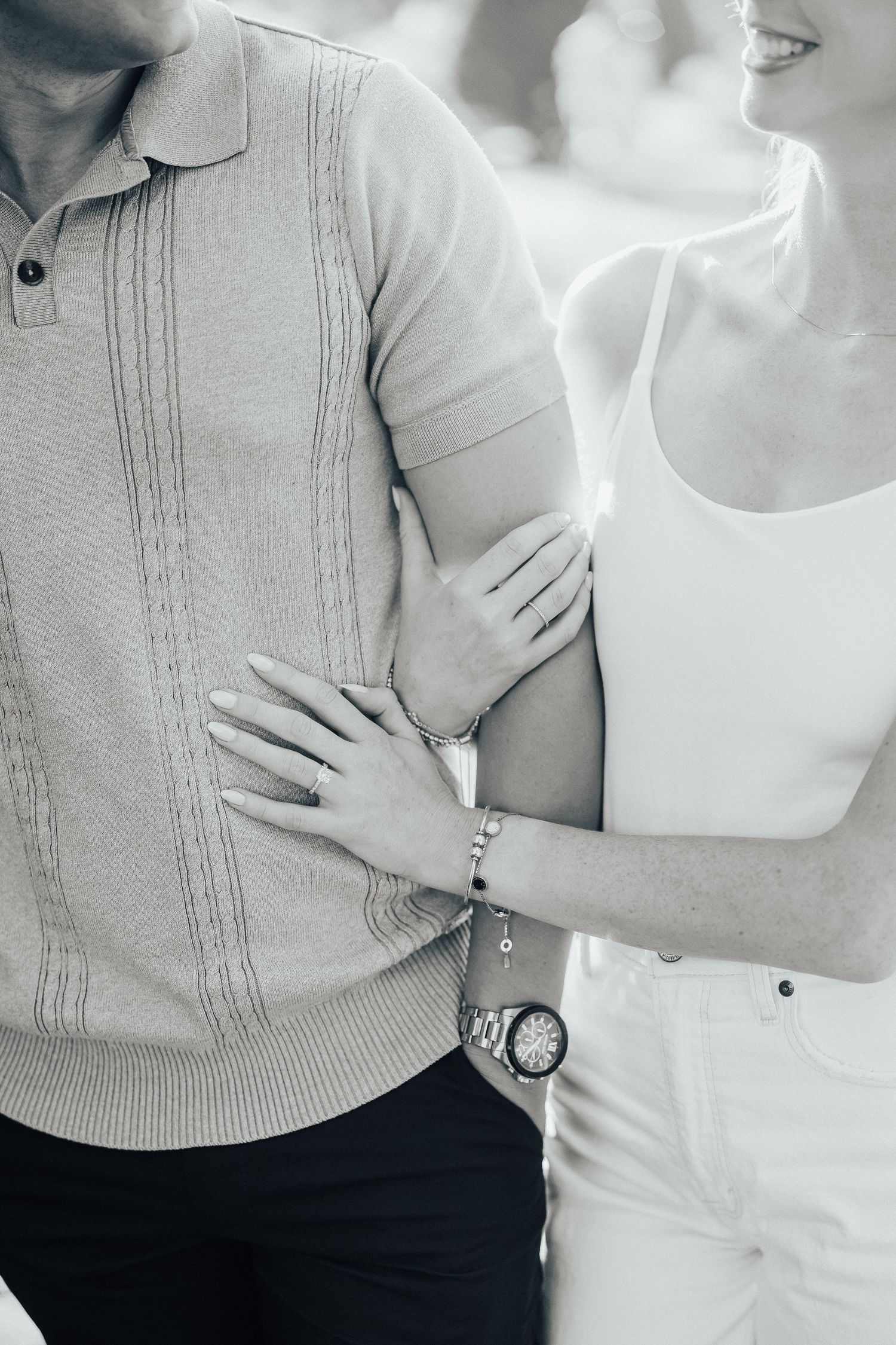 Couple in neutral tones wearing white and beige embracing in a romantic photoshoot showing affection and connection.