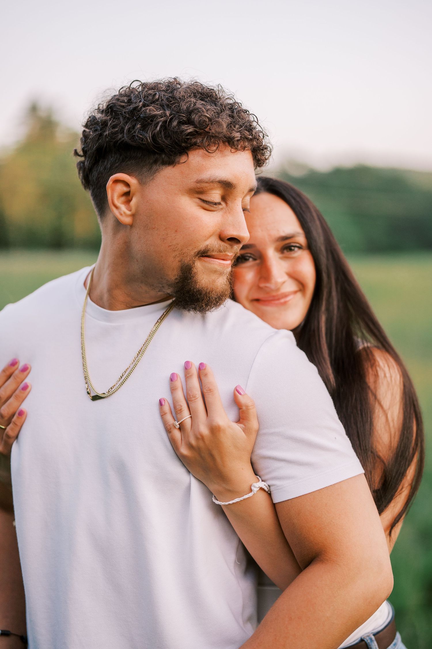 A loving couple shares intimate embraces in a series of romantic outdoor portrait photos at sunset.